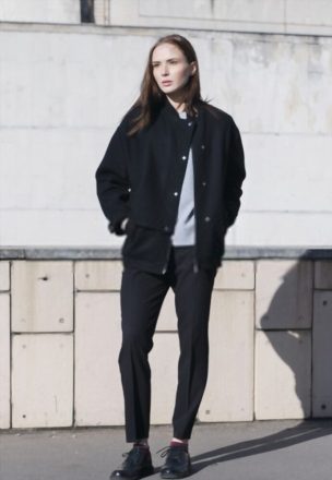 Black Sneakers With Distressed Skinny Jeans and A Neutral Bomber Jacket