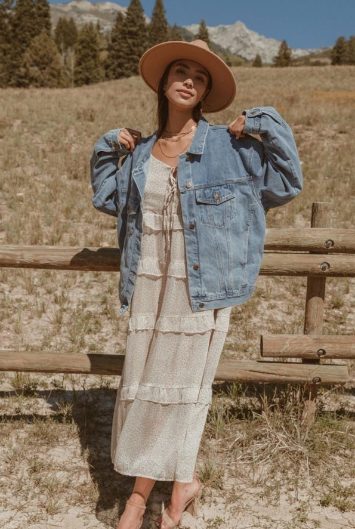 Oversized Denim Jacket Compared With a Ruffle Dress and a Wide-Brimmed Hat