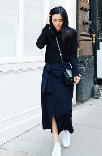 The Black Sweater Is Worn With A Wrap Skirt