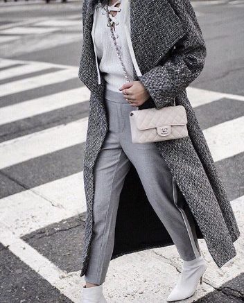 A White Sweater with a Charcoal Coat and Grey Pants