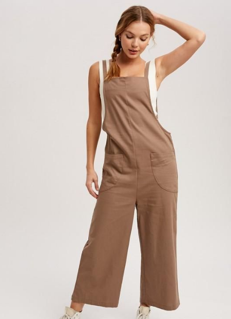 A White Tank Top With Brown Overalls