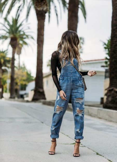 A Black Long-Sleeved Top With Ripped Denim Overalls