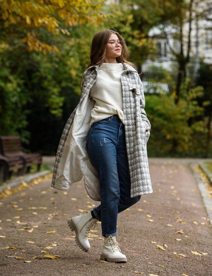 White sweater and navy jeans