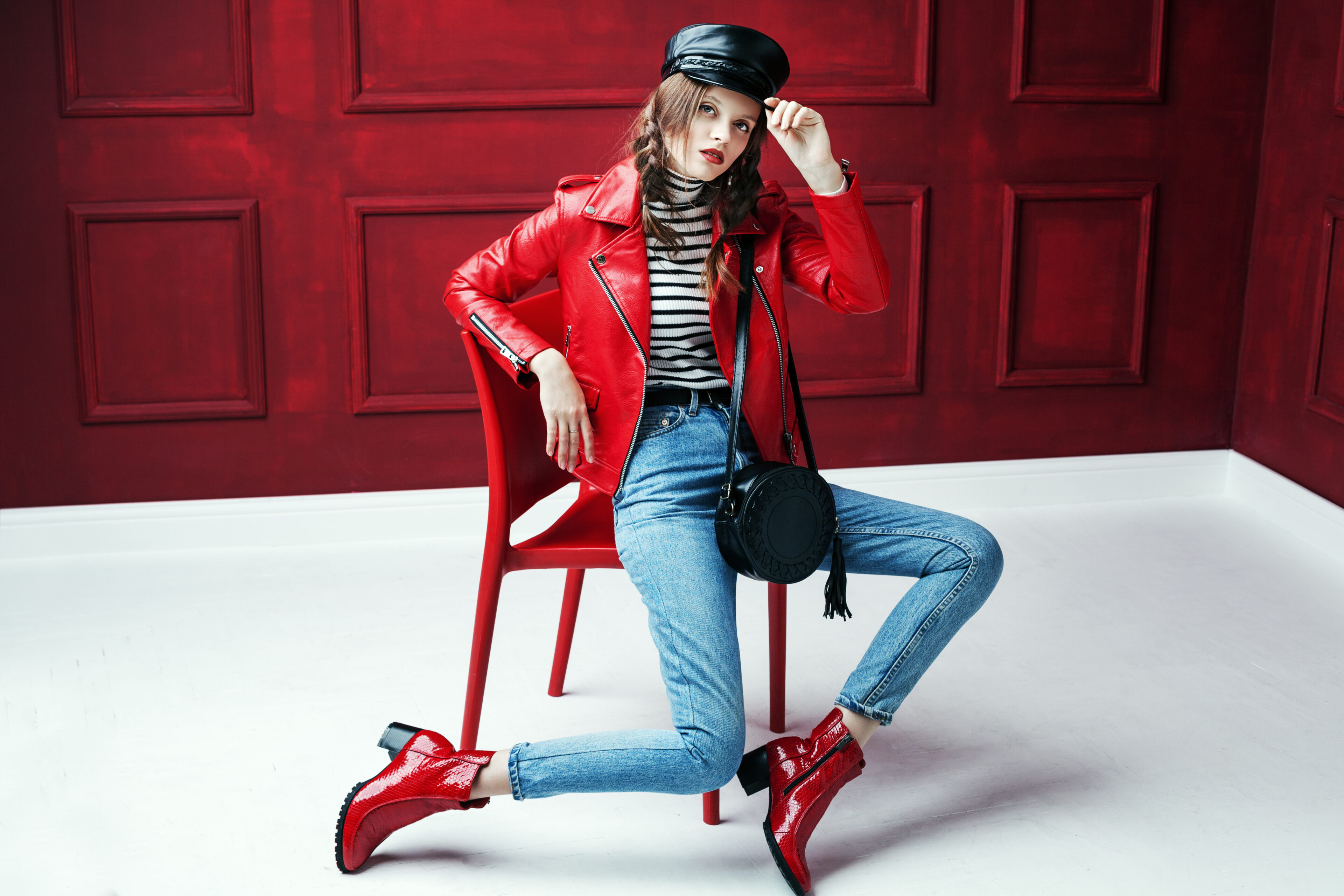 Leather Jacket With High Collar, Blue Jeans, And Red Ankle Boots