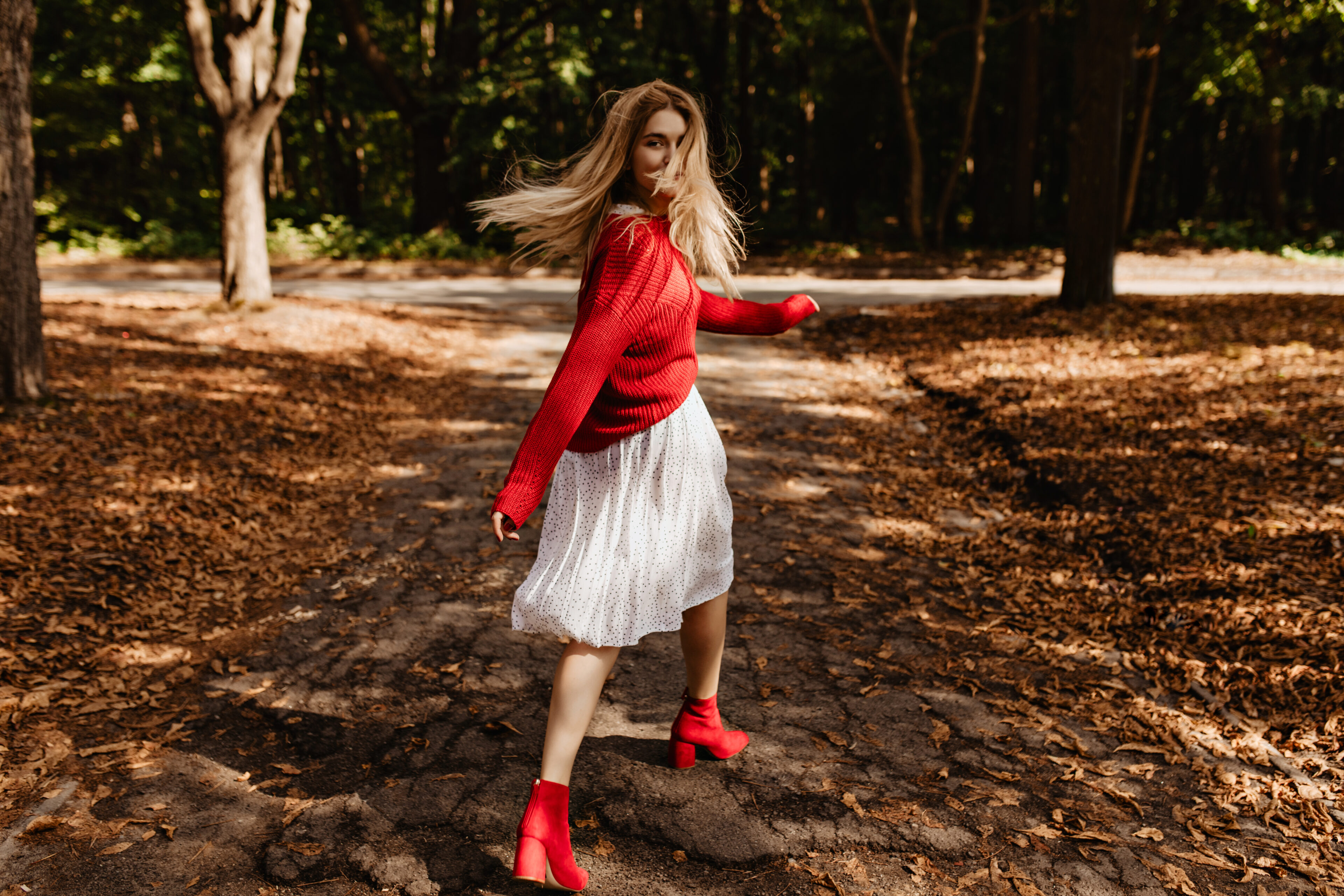 Red Sweater With A White Midi Skirt And Red Ankle Boots