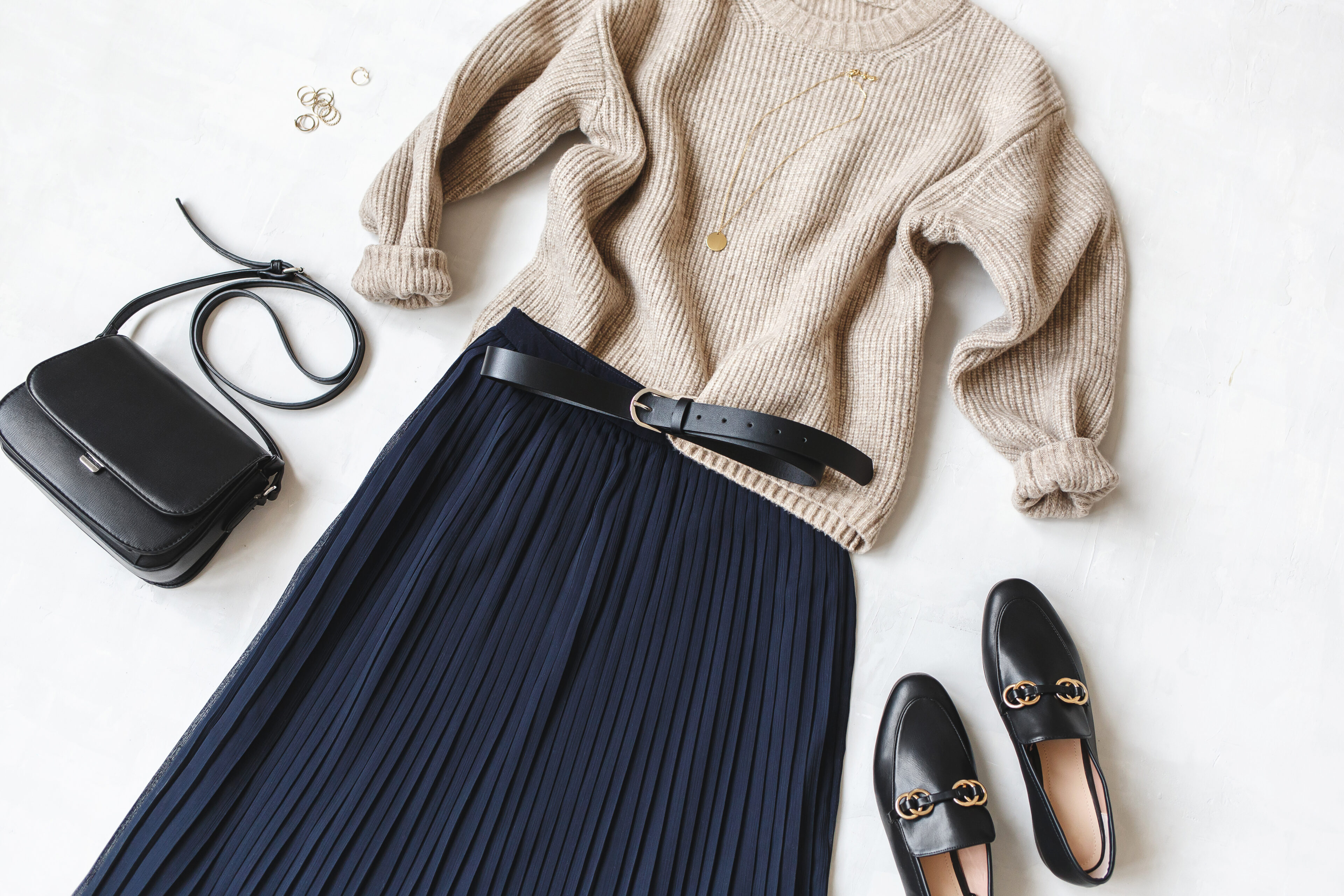 Blue Midi Pleated Skirt, Beige Knitted Sweater, Small Black Cross Body Bag, Belt, Loafers