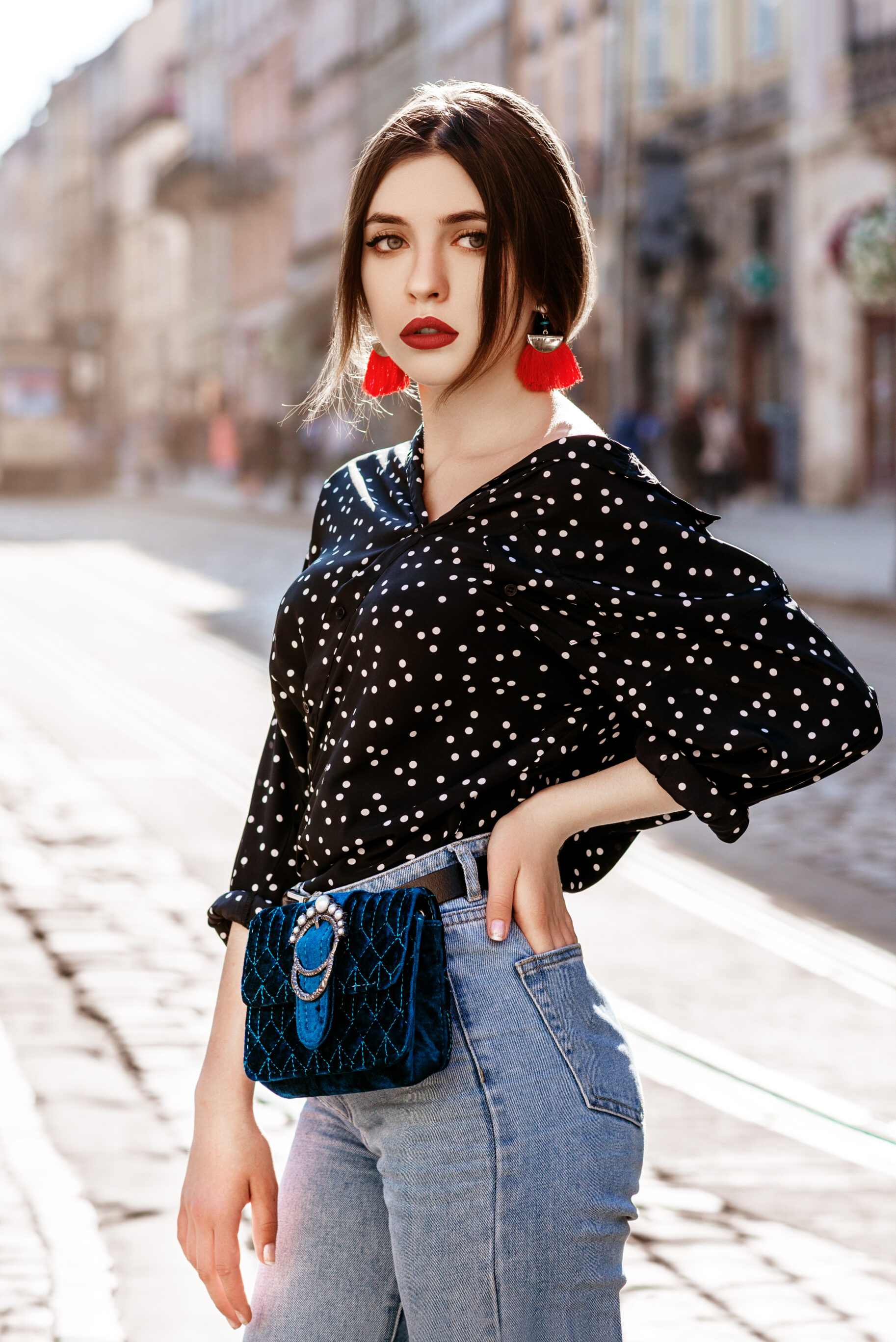 Red Tassel Earrings, Polka Dot Blouse, Jeans & Blue Waist Bag