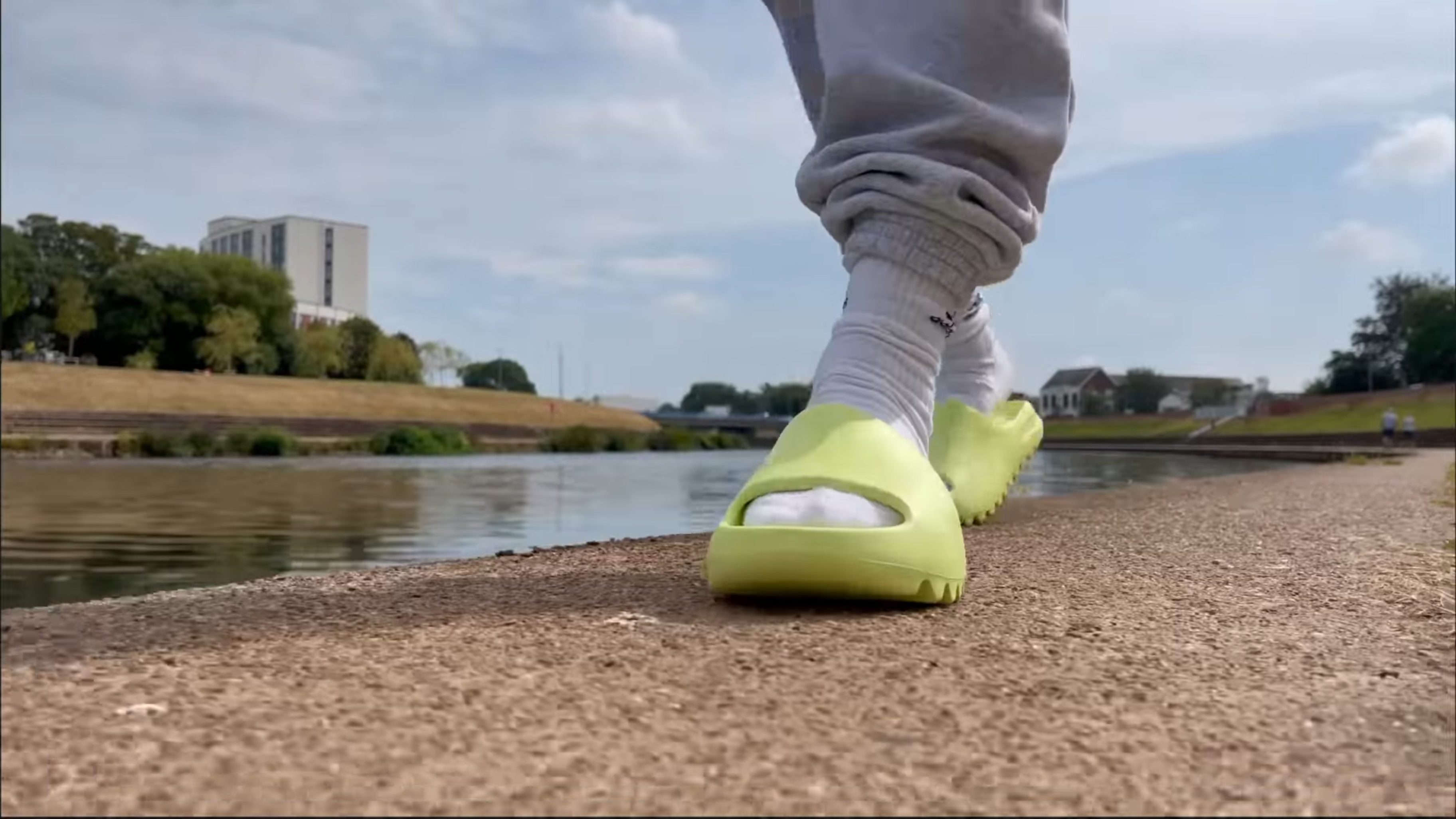Yeezy Slides 2022 Walking on road with socks on
