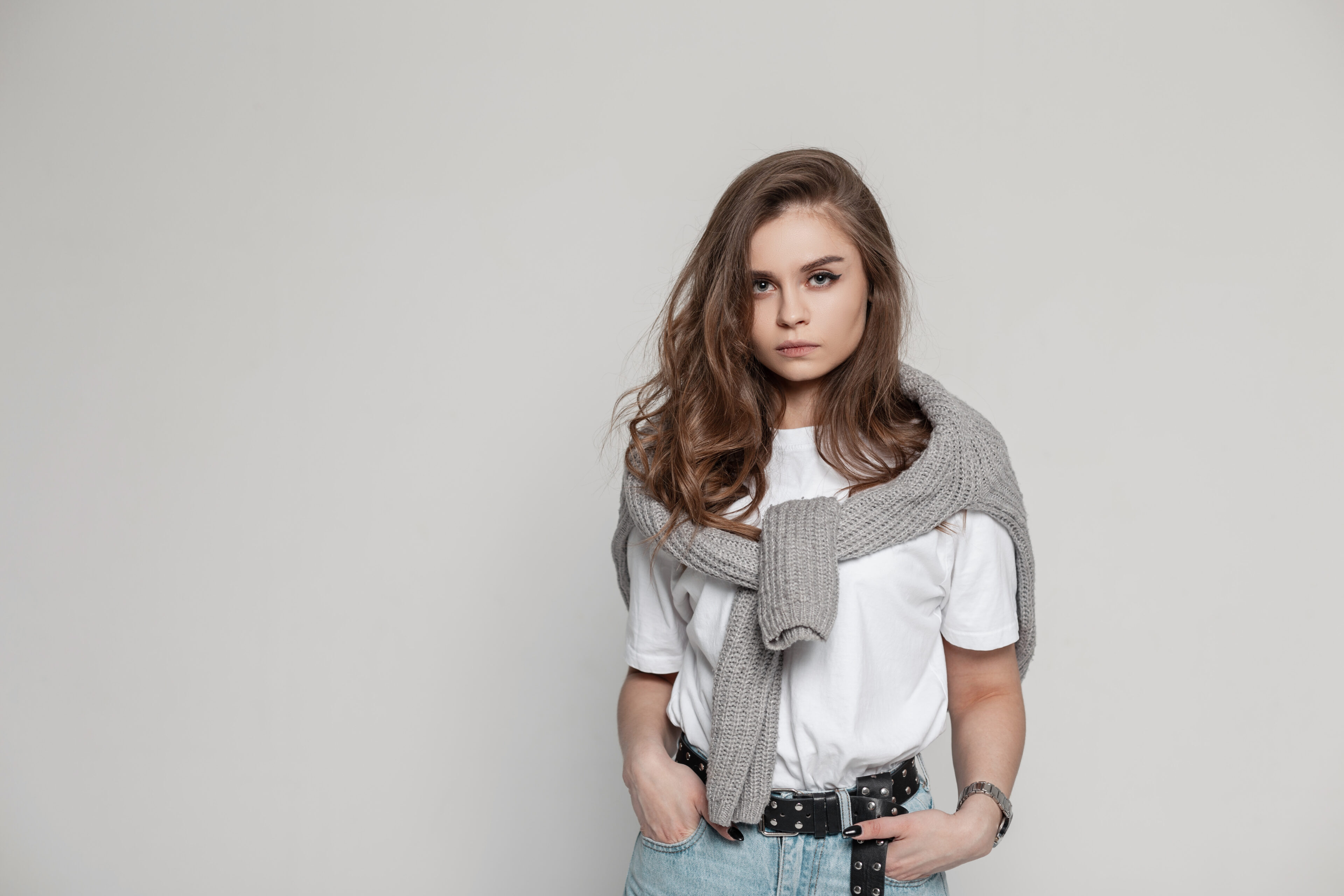 A Knitted Sweater, White T-Shirt, And Blue Jeans