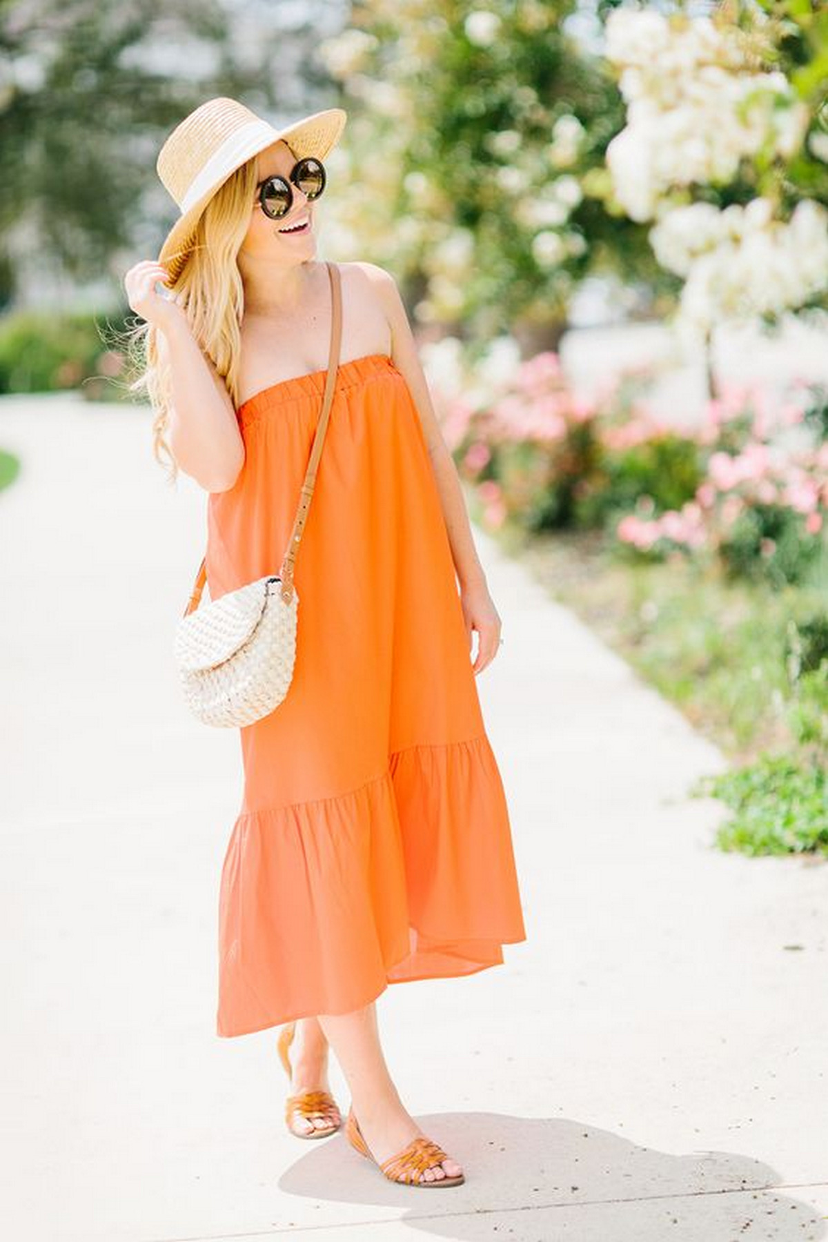 Woman wears a loose dress with orange shoes.