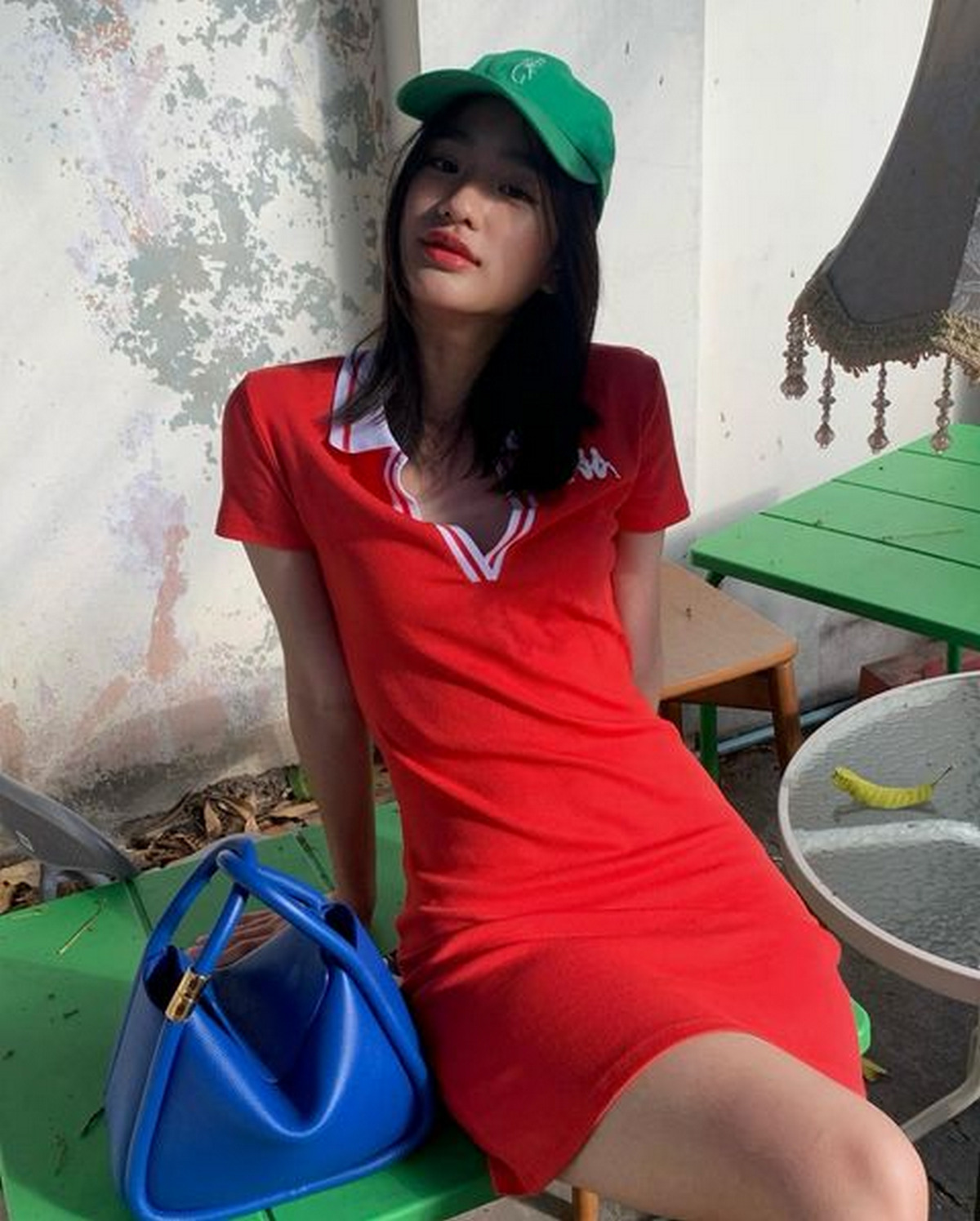 Red Sporty Dress With Green Cap And Blue Handbag