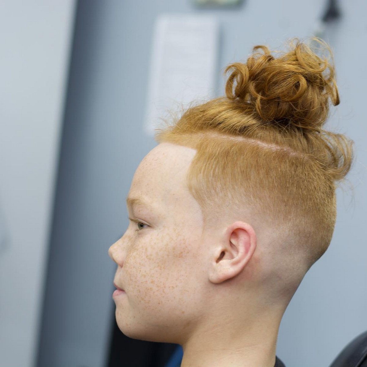 Blonde Low Taper Undercut With Messy High Bun