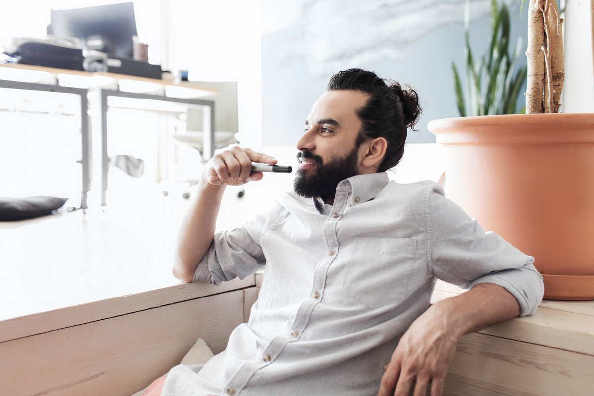 Black Puffy Swept-Back Bangs With A Man Bun