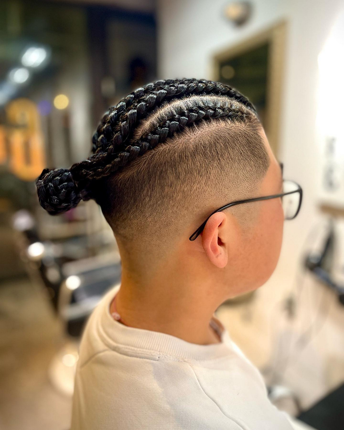 Cornrow Hair As A Bun With Shaved Sides