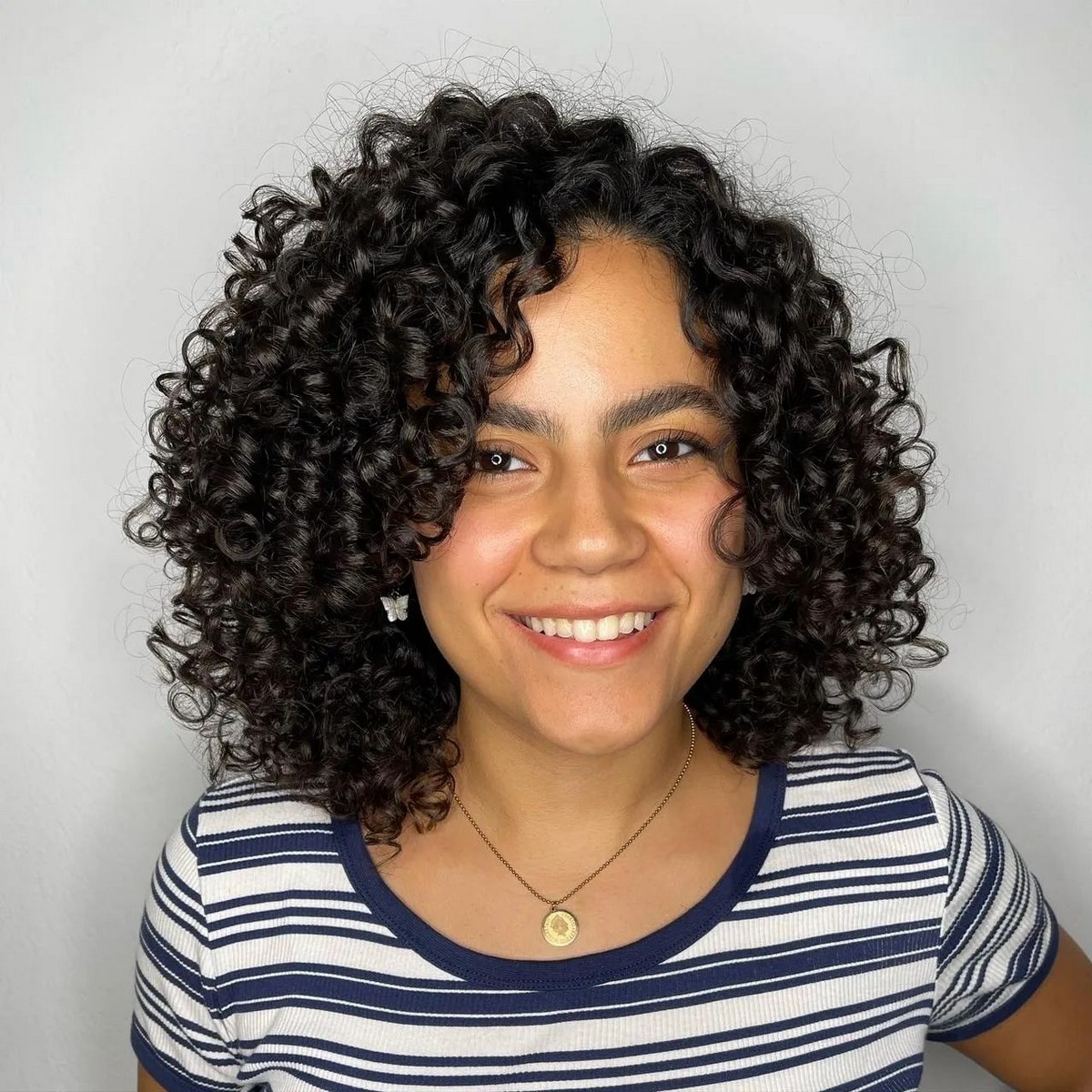 Round-Shaped Layered Bob With Bouncy Curls