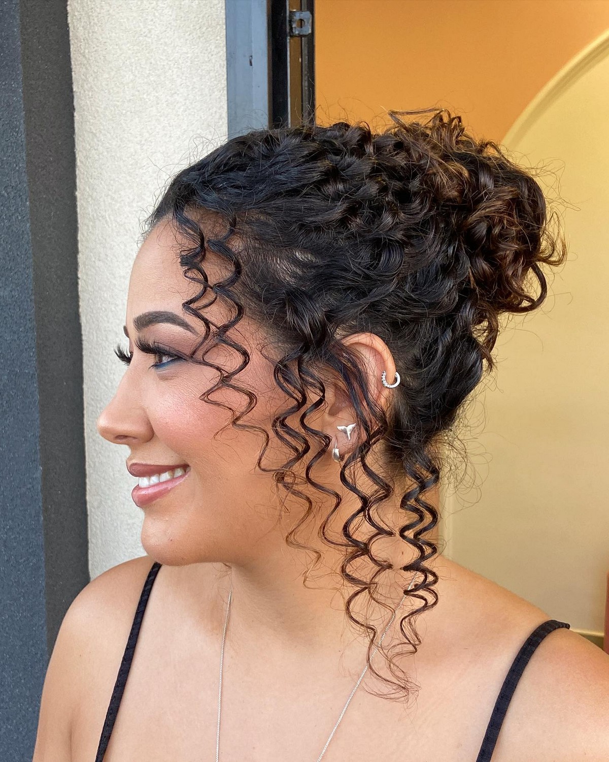 High Bun And Face-Framing Spirals