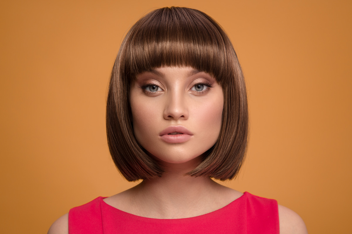 Brown Round Bob With Bangs Above The Eyebrows