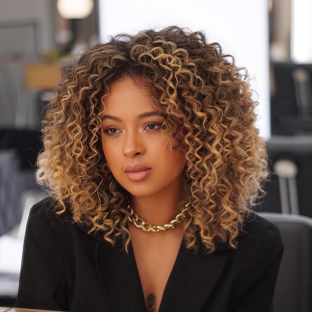 Modern Short Curly Hair With Blonde Highlights And A Middle Part 