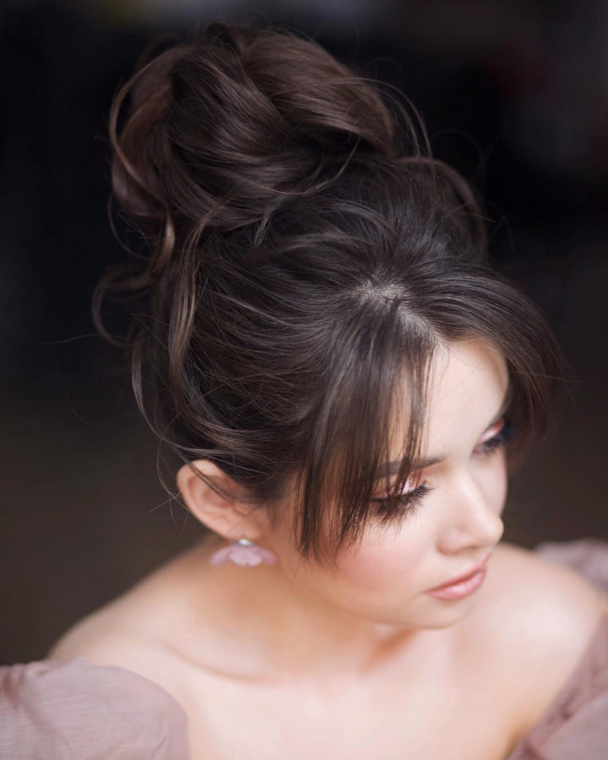 Messy High Bun With Piece-Y Side Bangs