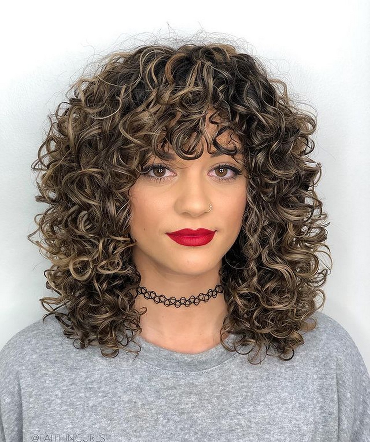 Mid-Length Curly Hairstyle With Curly Bangs
