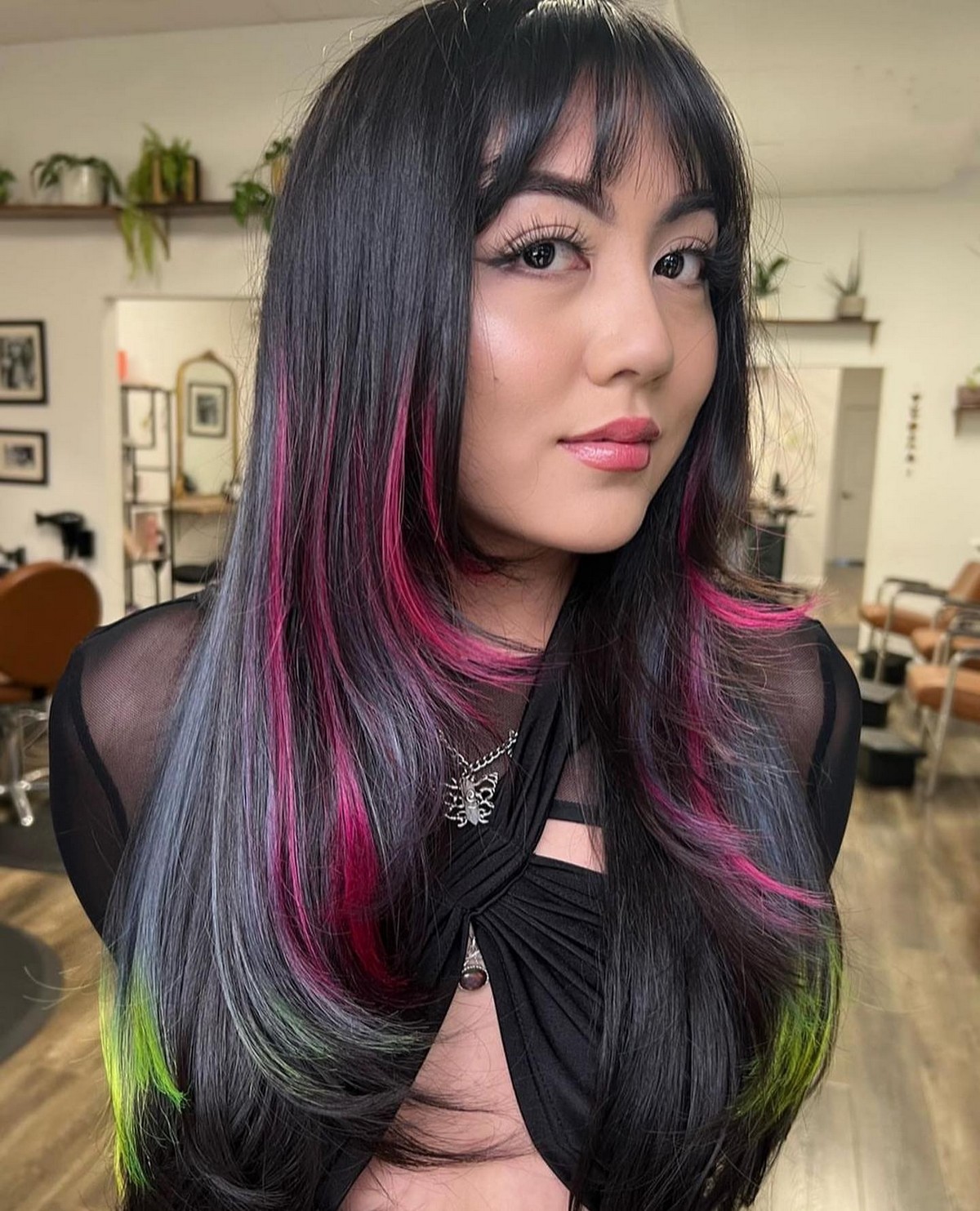 Black Layered Hair With Colored Highlights And Wispy Bangs