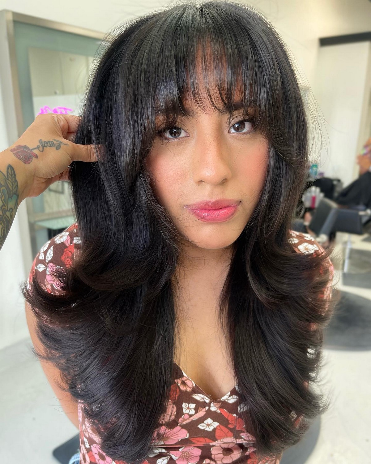 Arched Bangs And Brunette Blowout Hairstyle