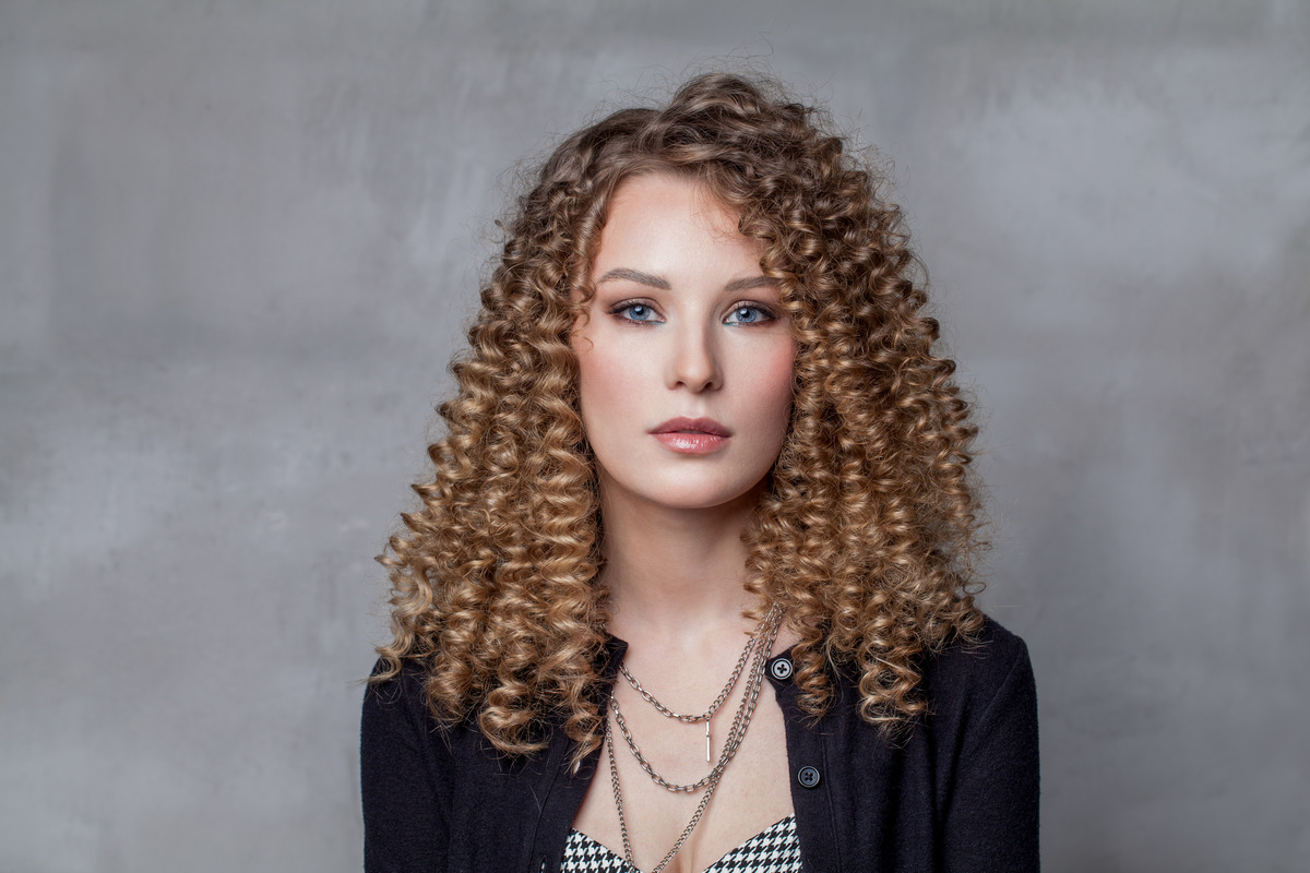 Blonde Springy Curls With Side-Swept Bangs