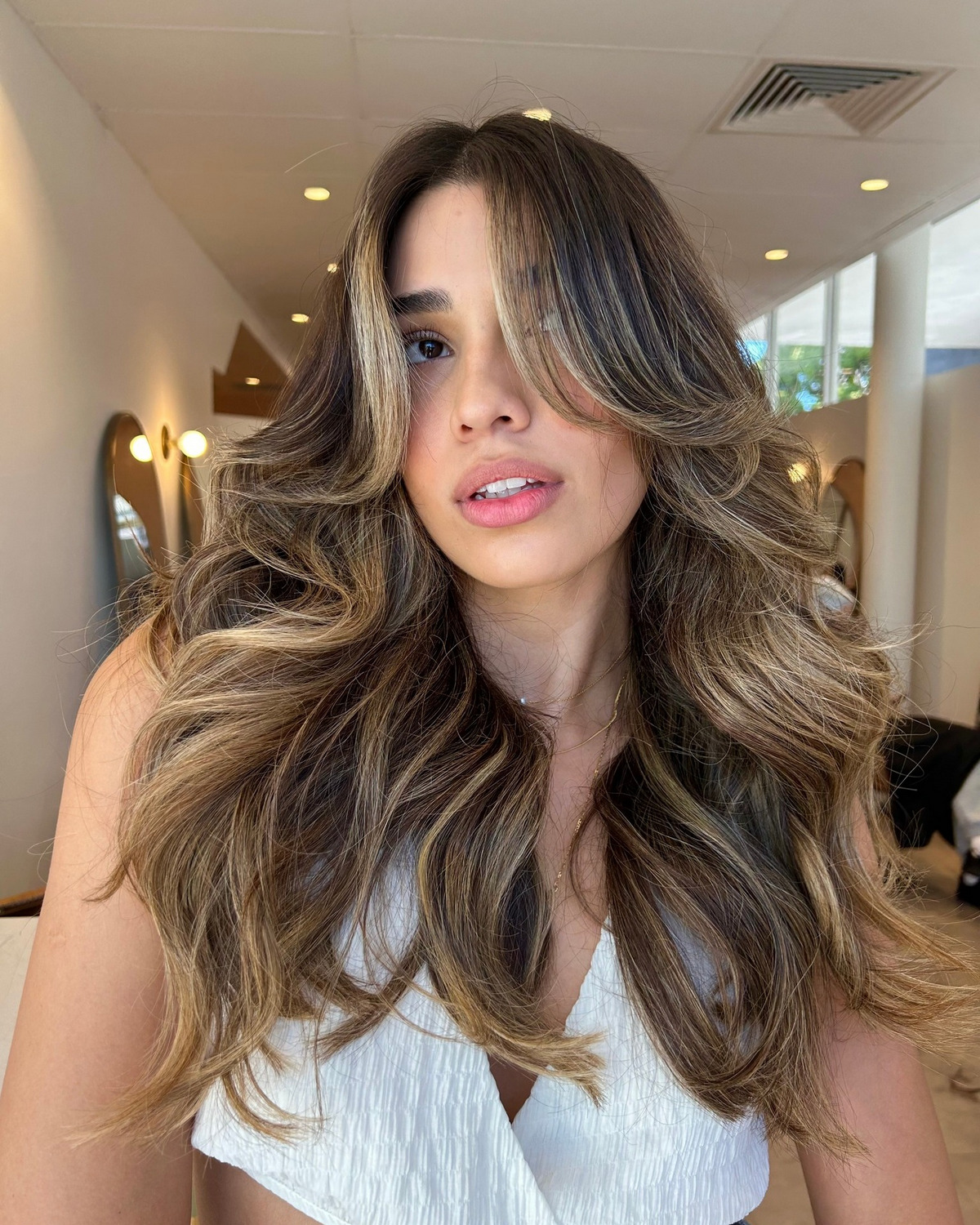 Long Layers With Bouncy Curls And Curtain Bangs
