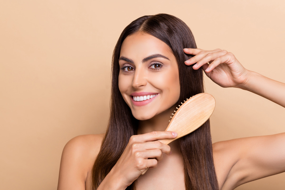 A Girl is brushing her hair gently