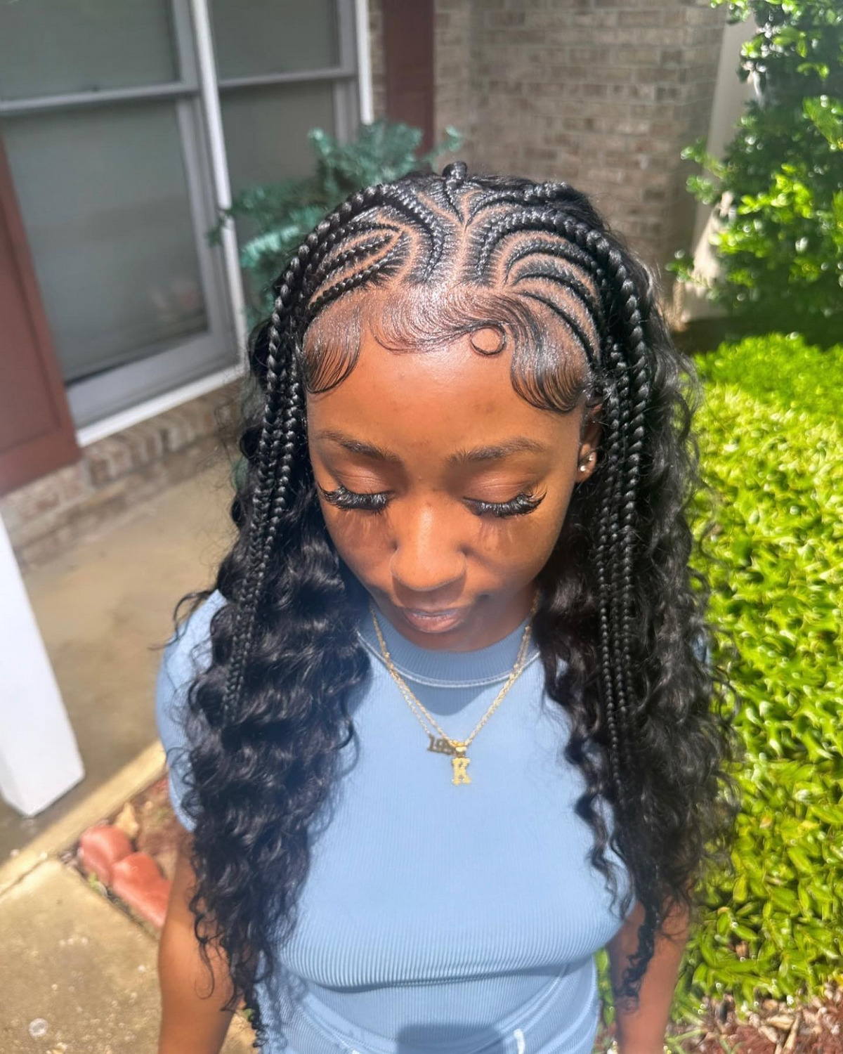 A half up half down quick weave with stitch braids
