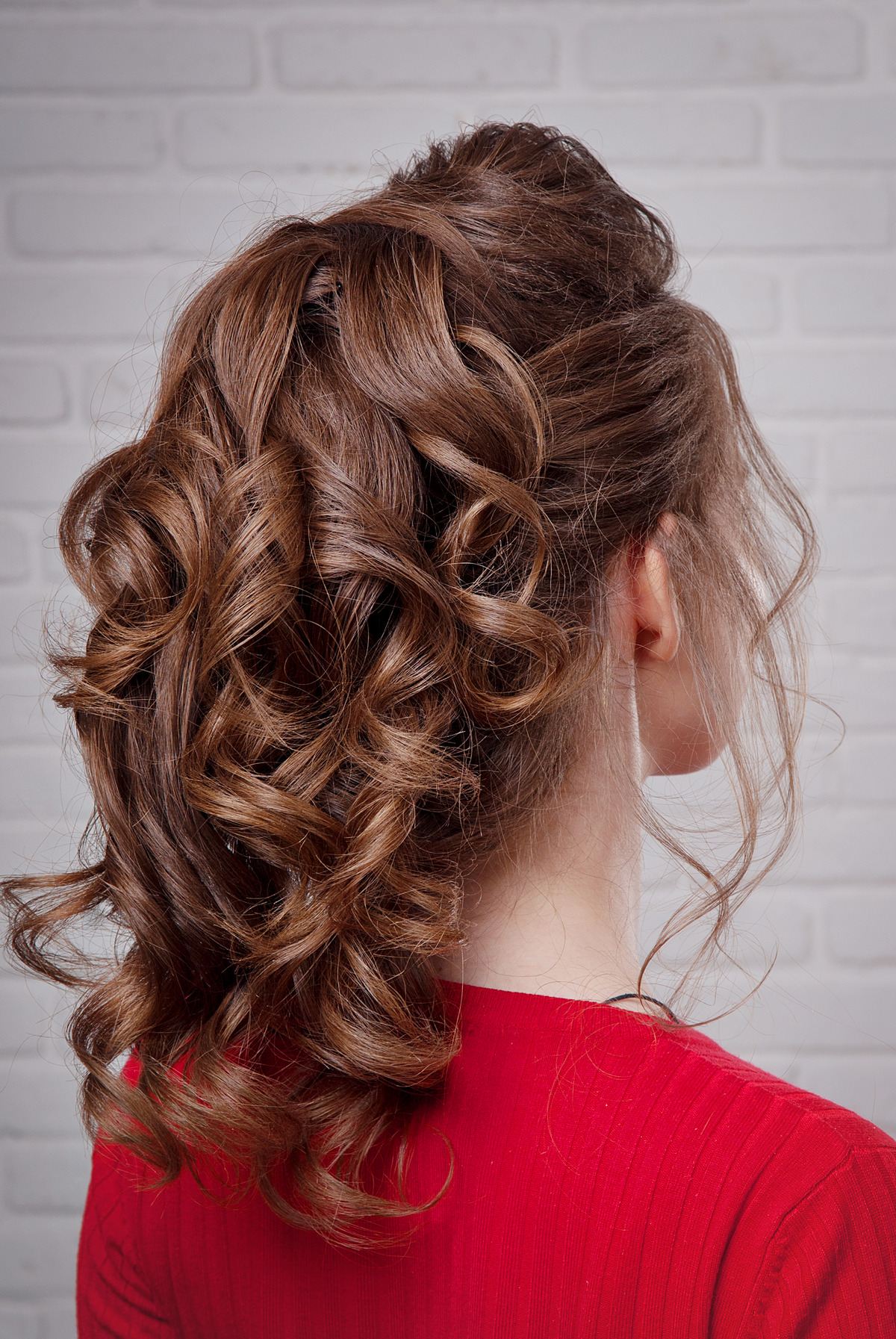 Active girl with balayage highlight hair tied in a ponytail.