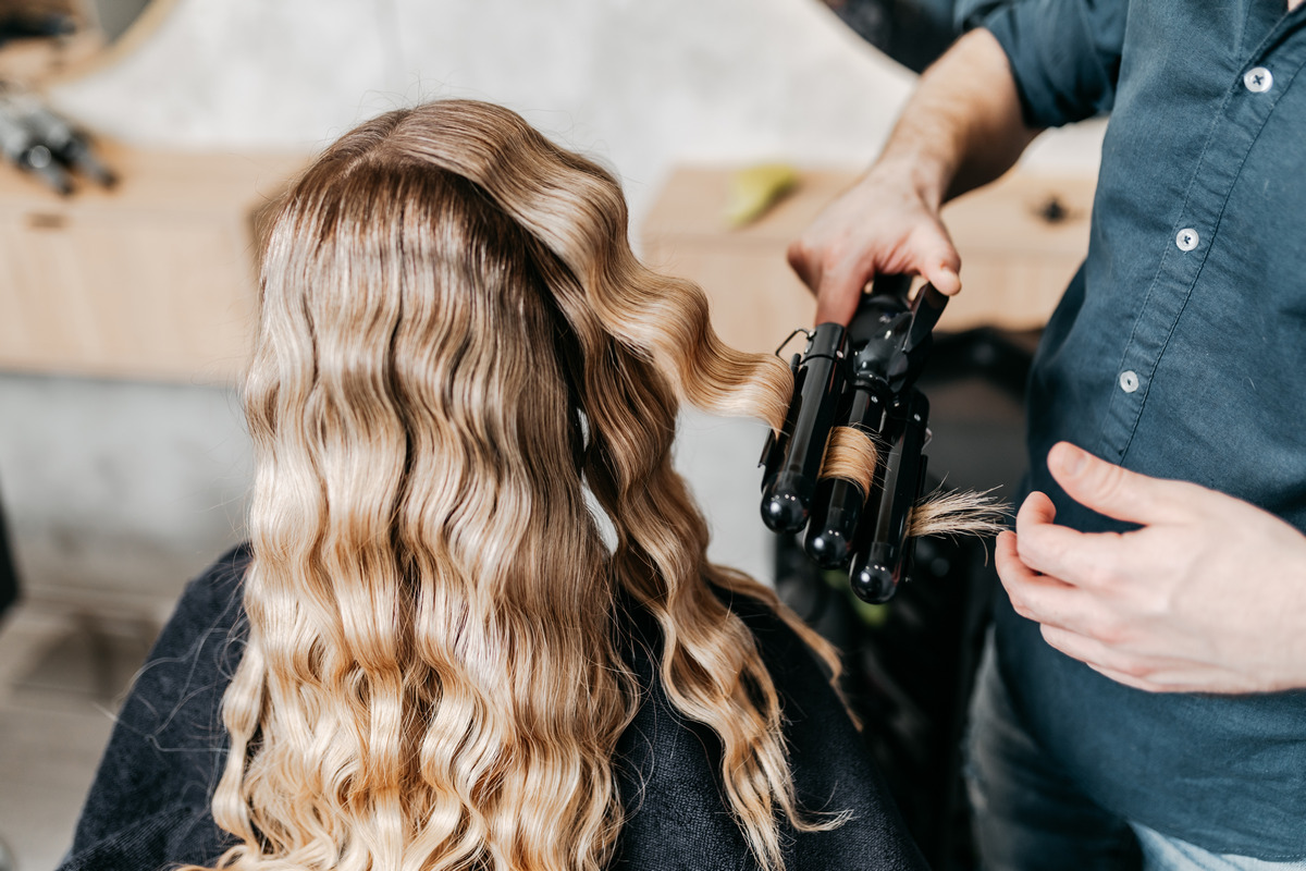 Beautiful hairstyle of a young blond woman after dyeing hair and making highlights