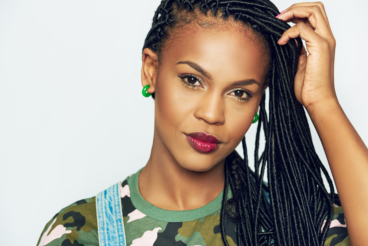Beautiful woman with accurate black dreadlocks