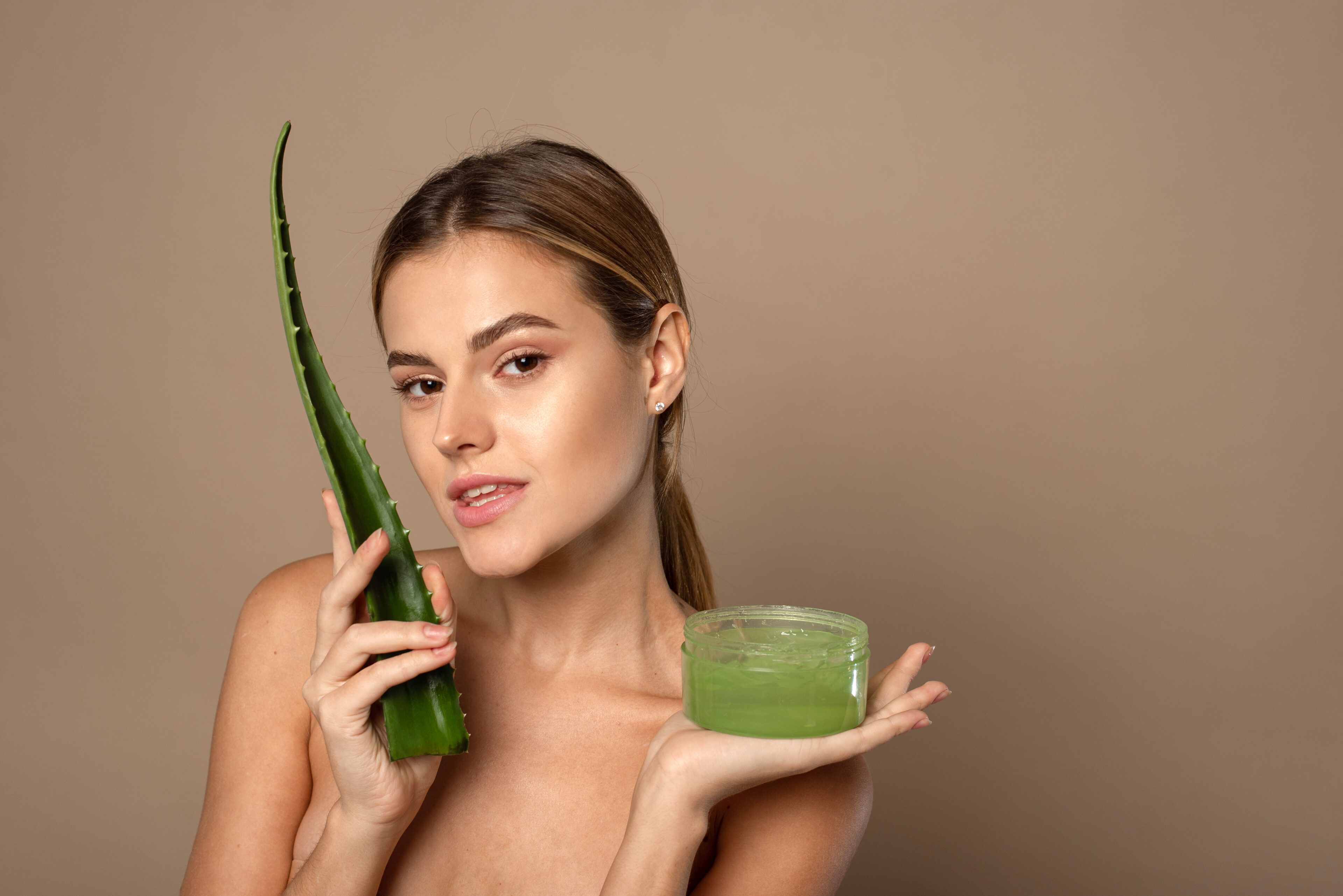 A young woman uses aloe vera gel on her hair