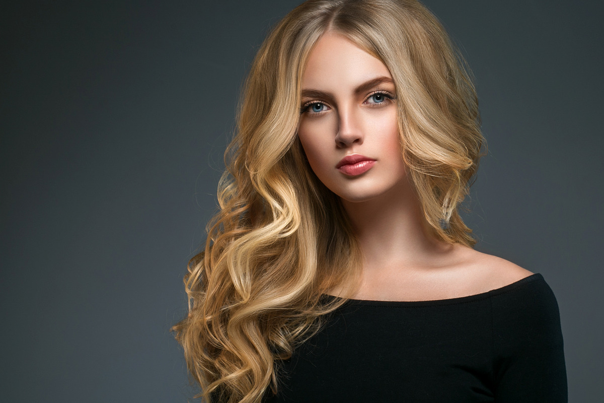 Charming girl with blonde curly hair