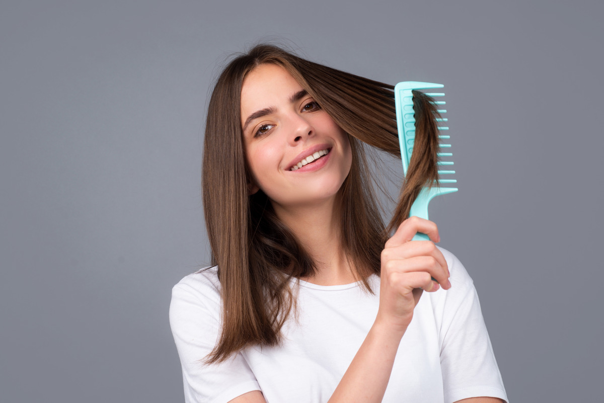 Combing healthy long straight female hair