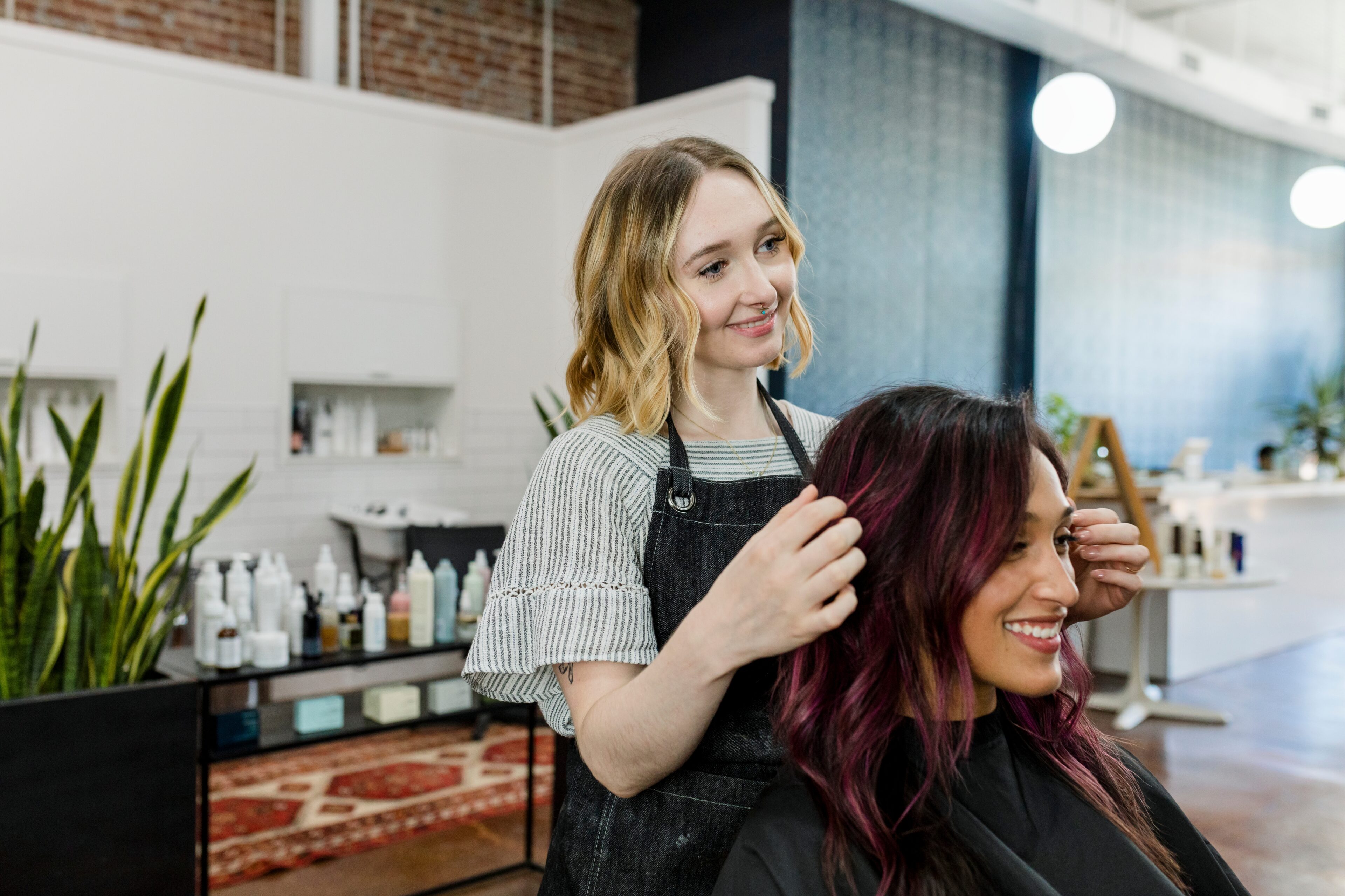 Hair stylist is consulting to her customer