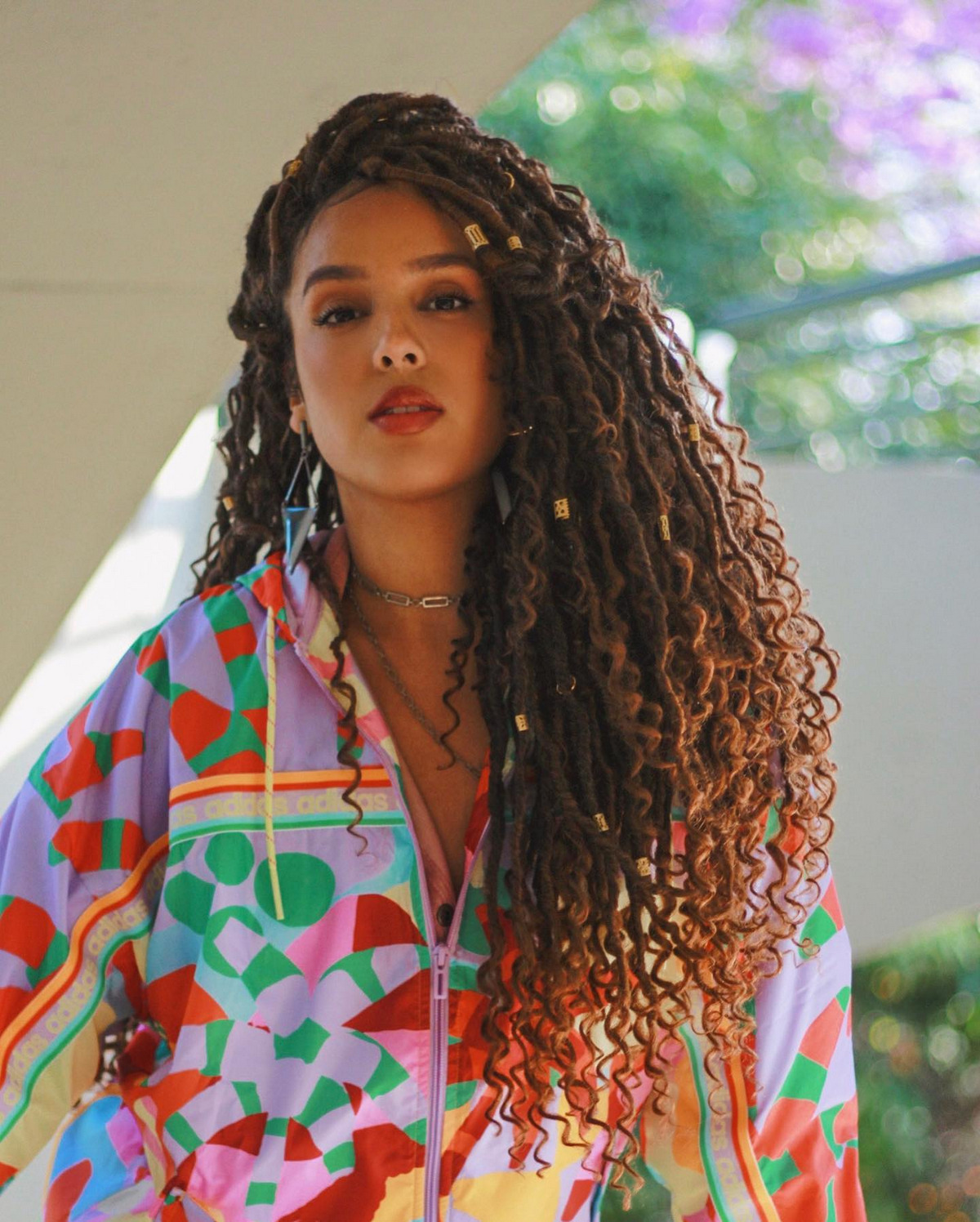Faux locs hairstyle with impressive golden knots