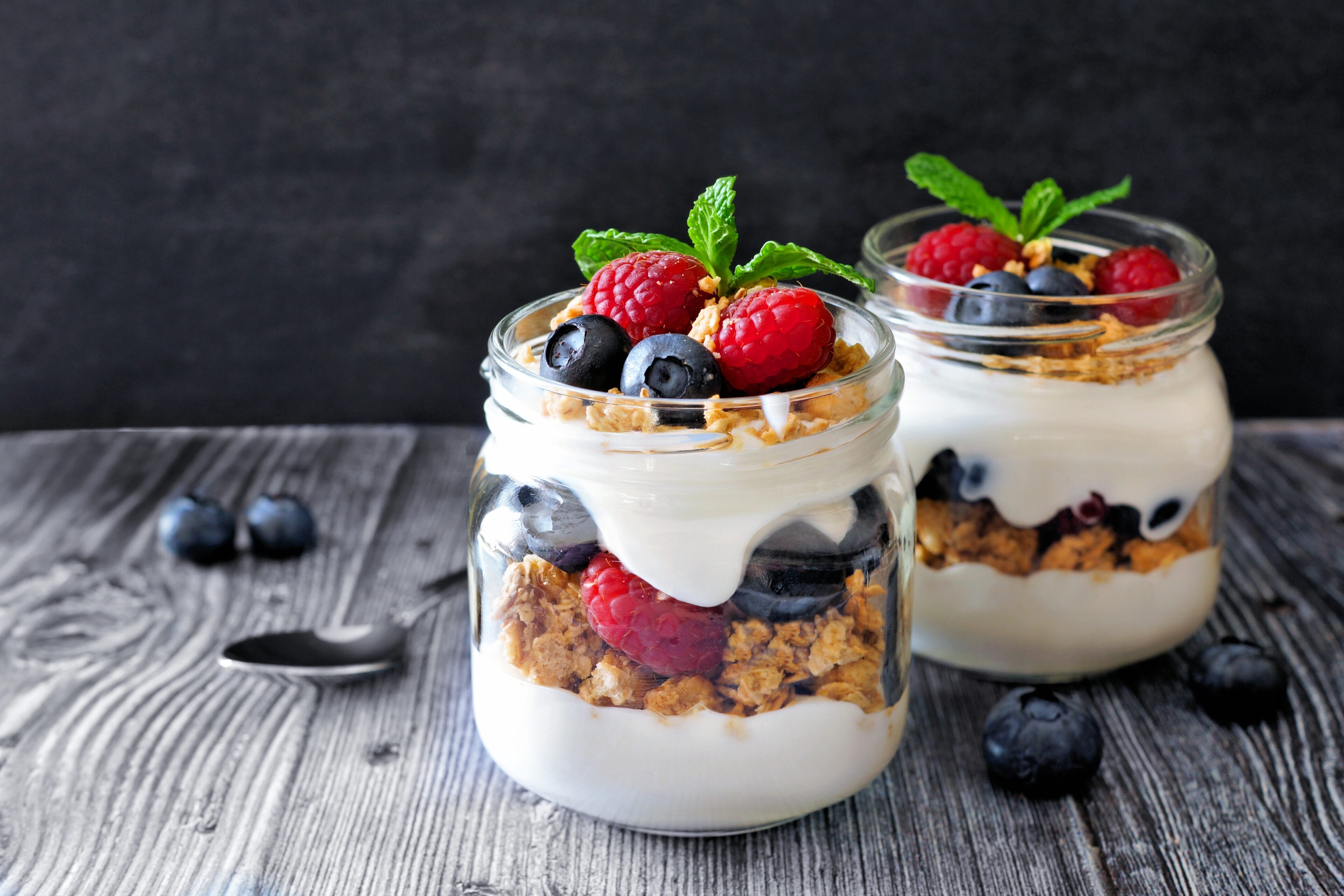 Greek yogurt and organic fruit in mason jars