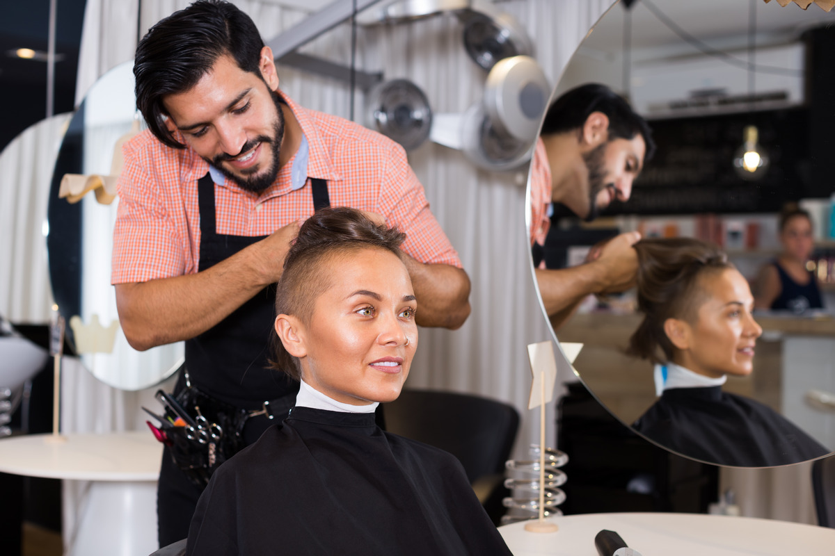 Hair stylist is styling customer’s hair