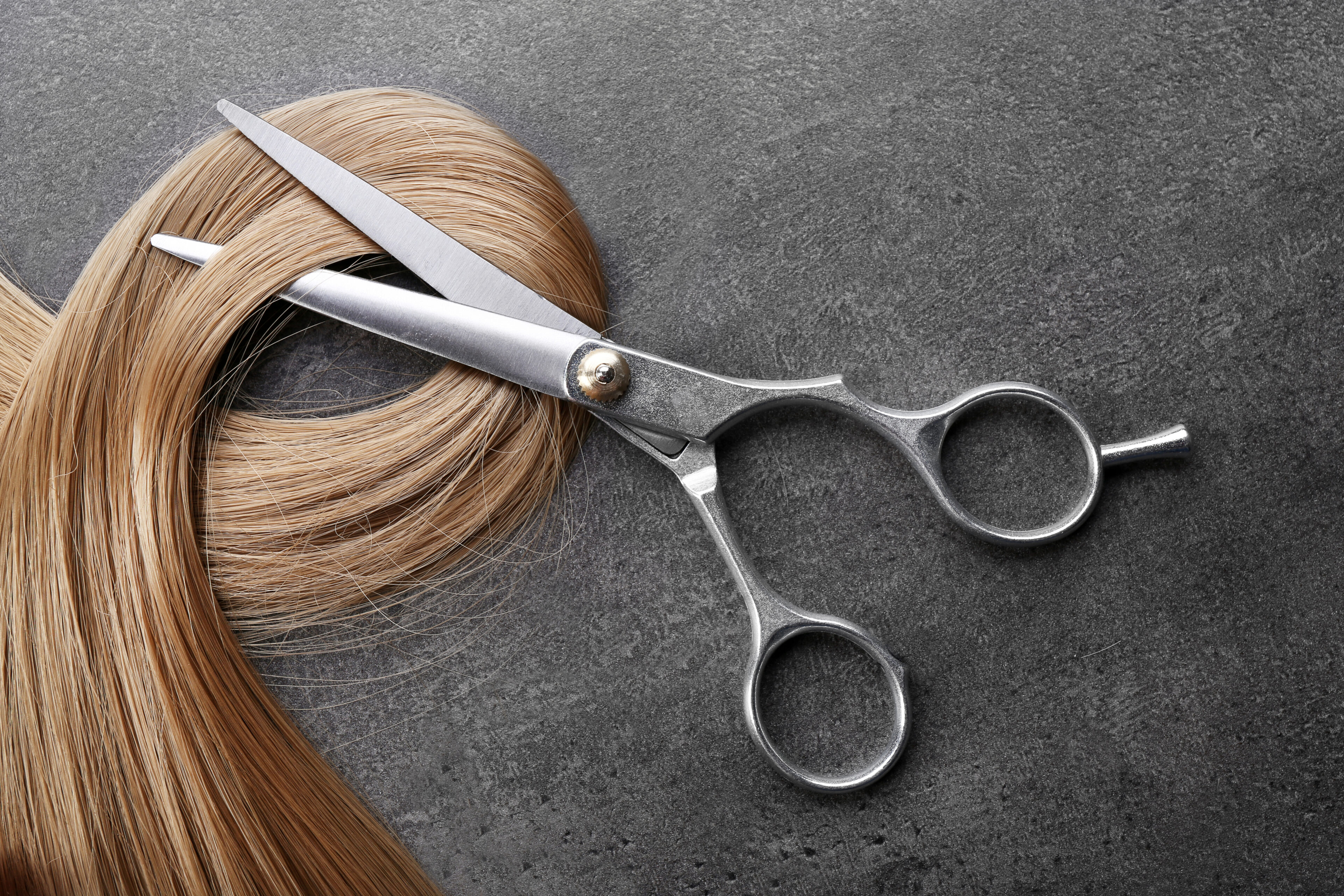 Scissors with strand of blonde hair