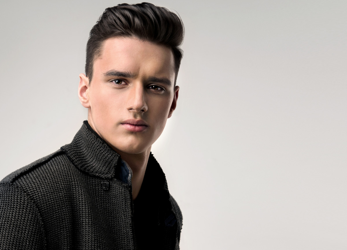 Handsome man with a trendy hairstyle in a stylish coat