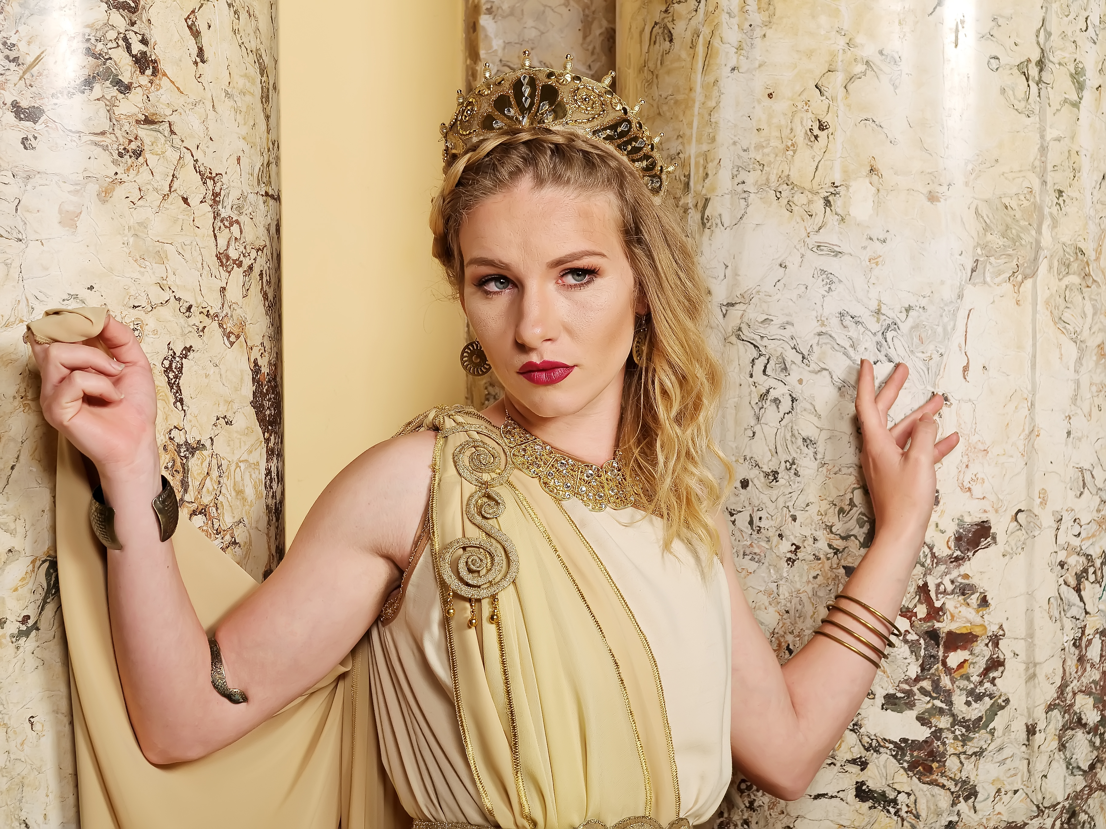 A woman wearing traditional Roman attire, adorned with braided hair