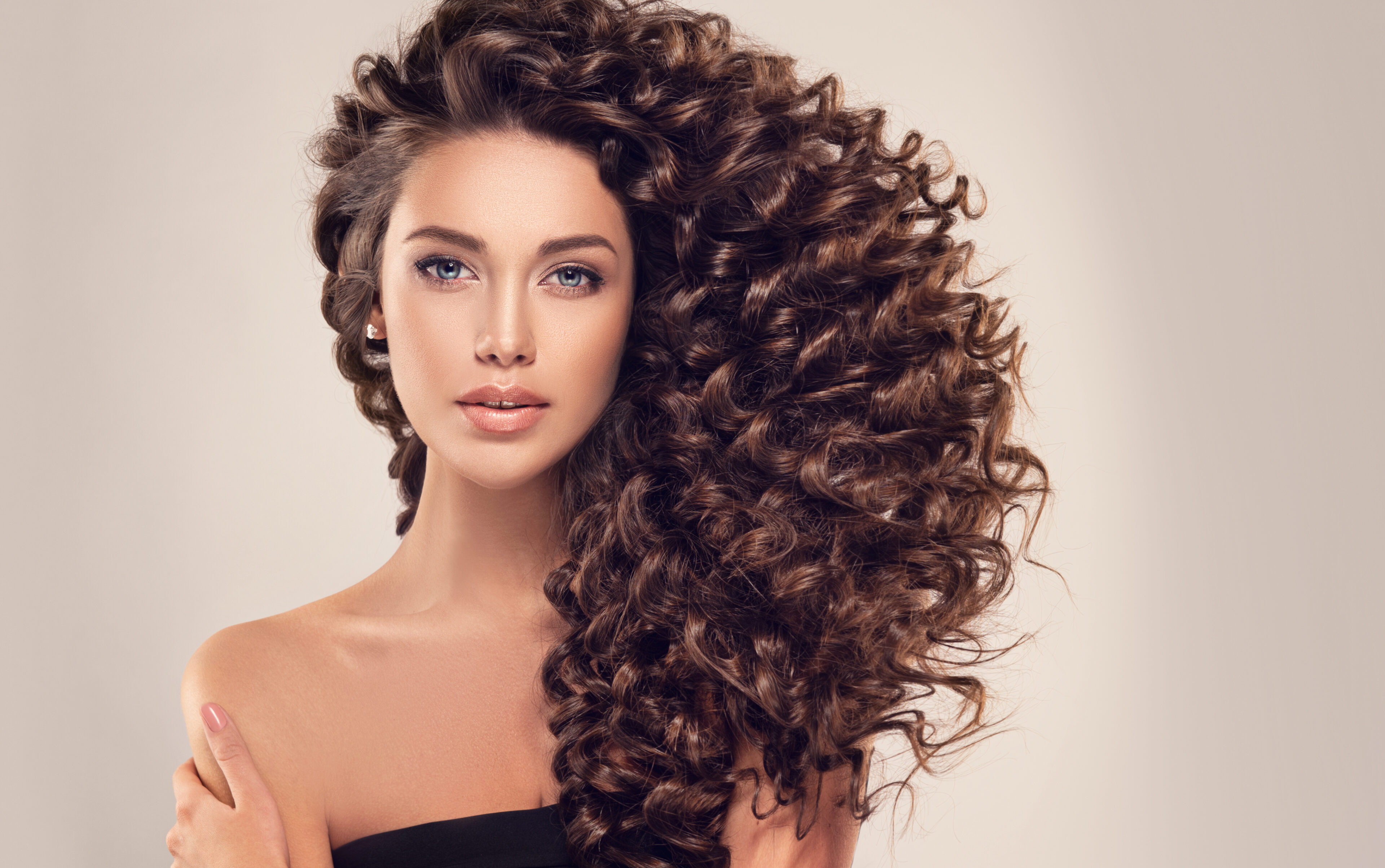 Brunette girl with long and shiny curly hair