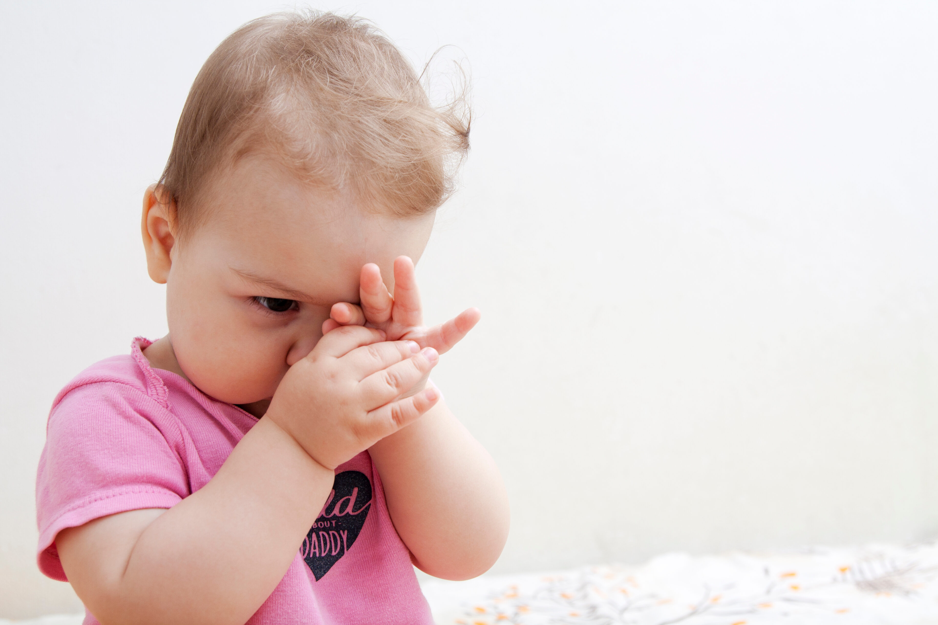 A baby is suffering from the hair in his eye