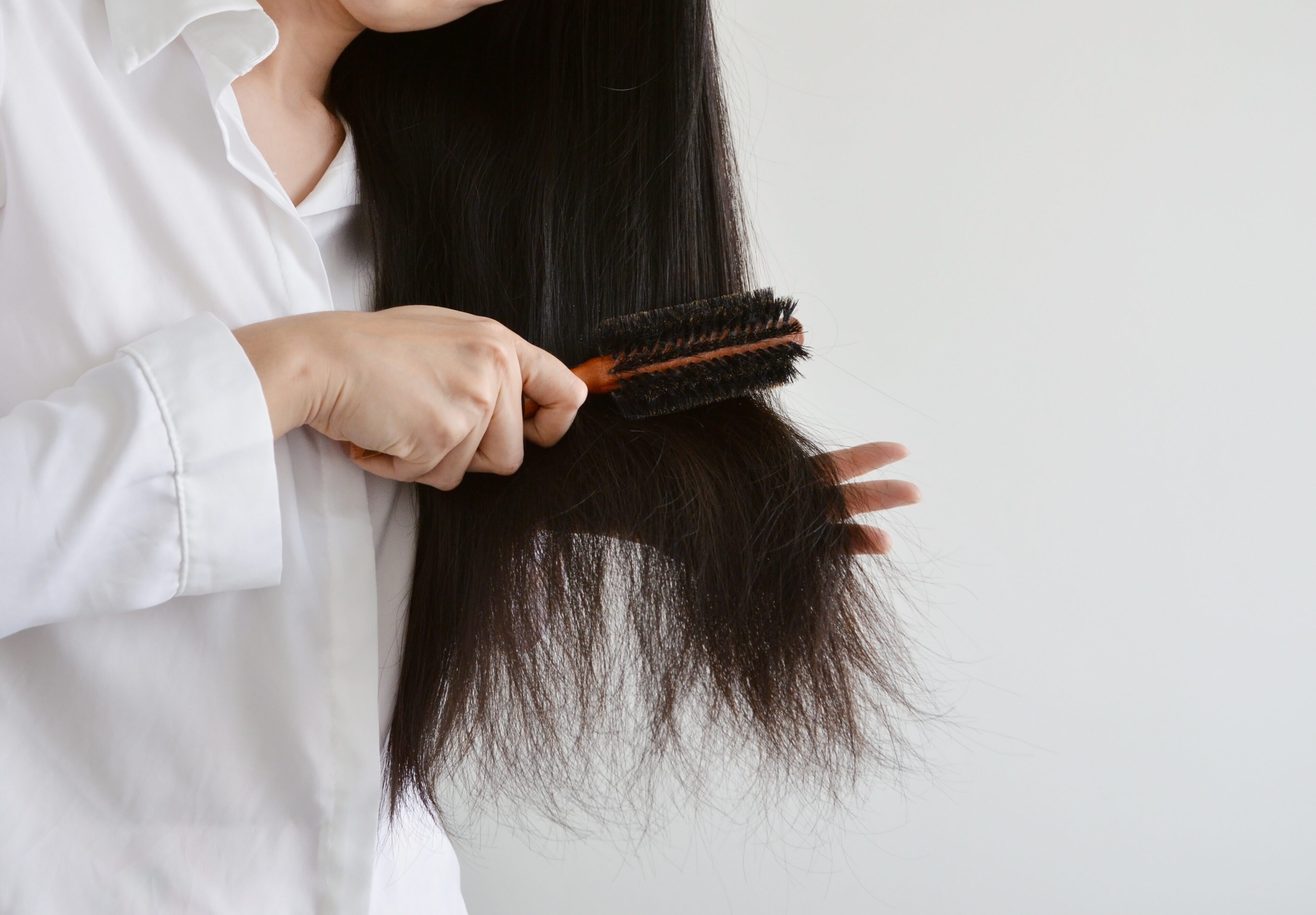 Using a paddle brush or a wide-tooth comb