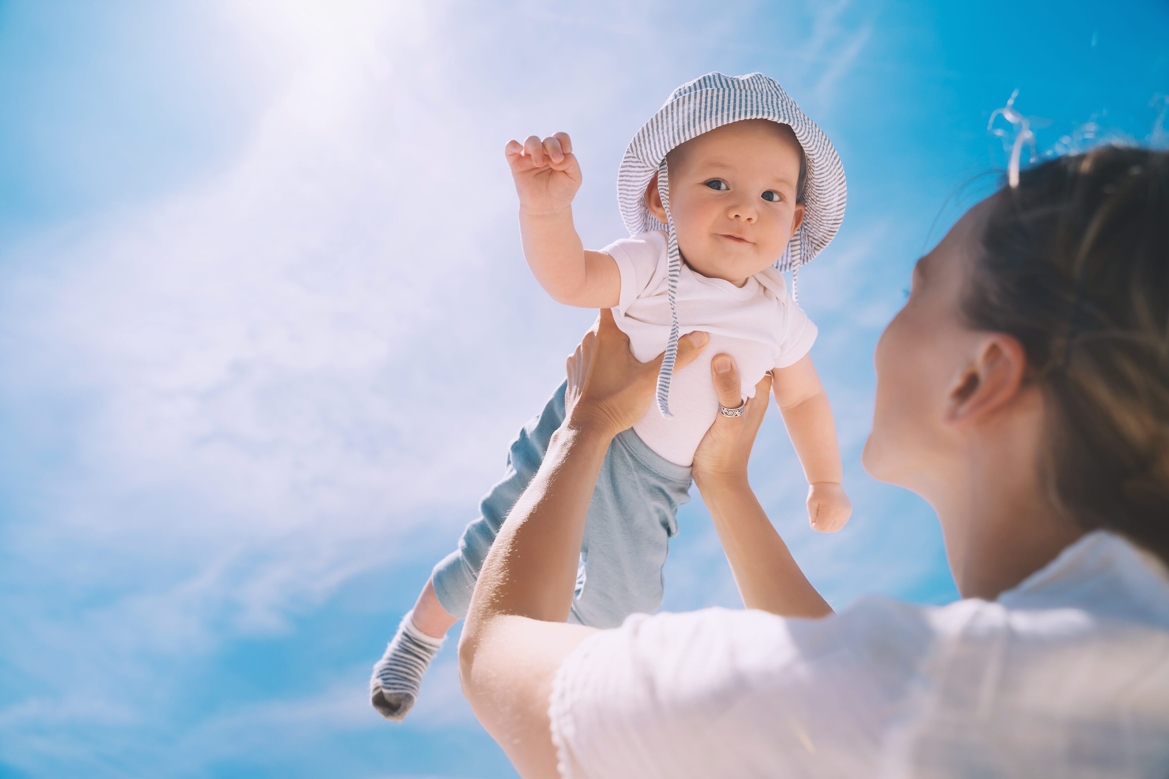 Baby wears hat outdoors