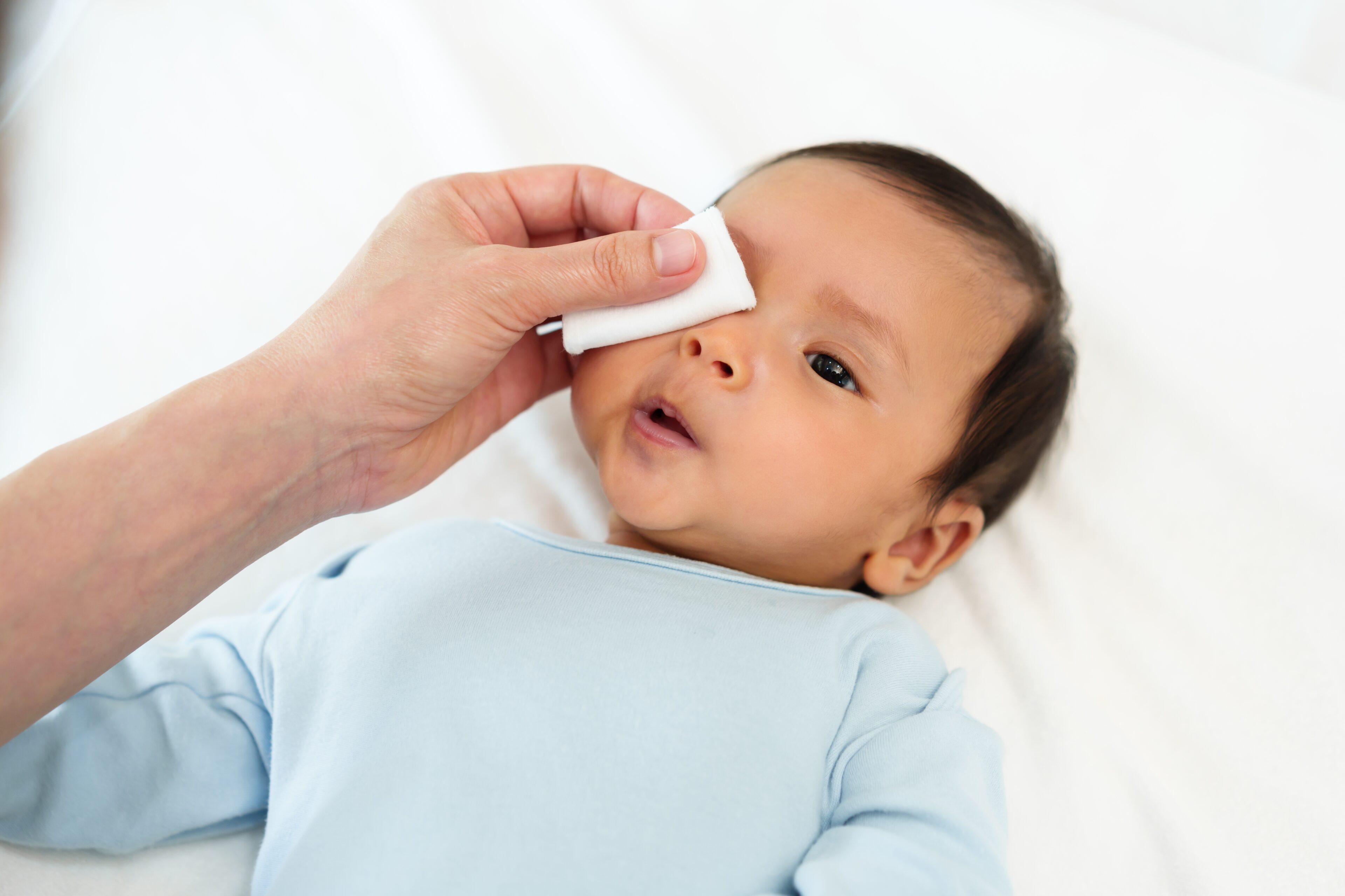 Gently dab the cloth around your baby's eye