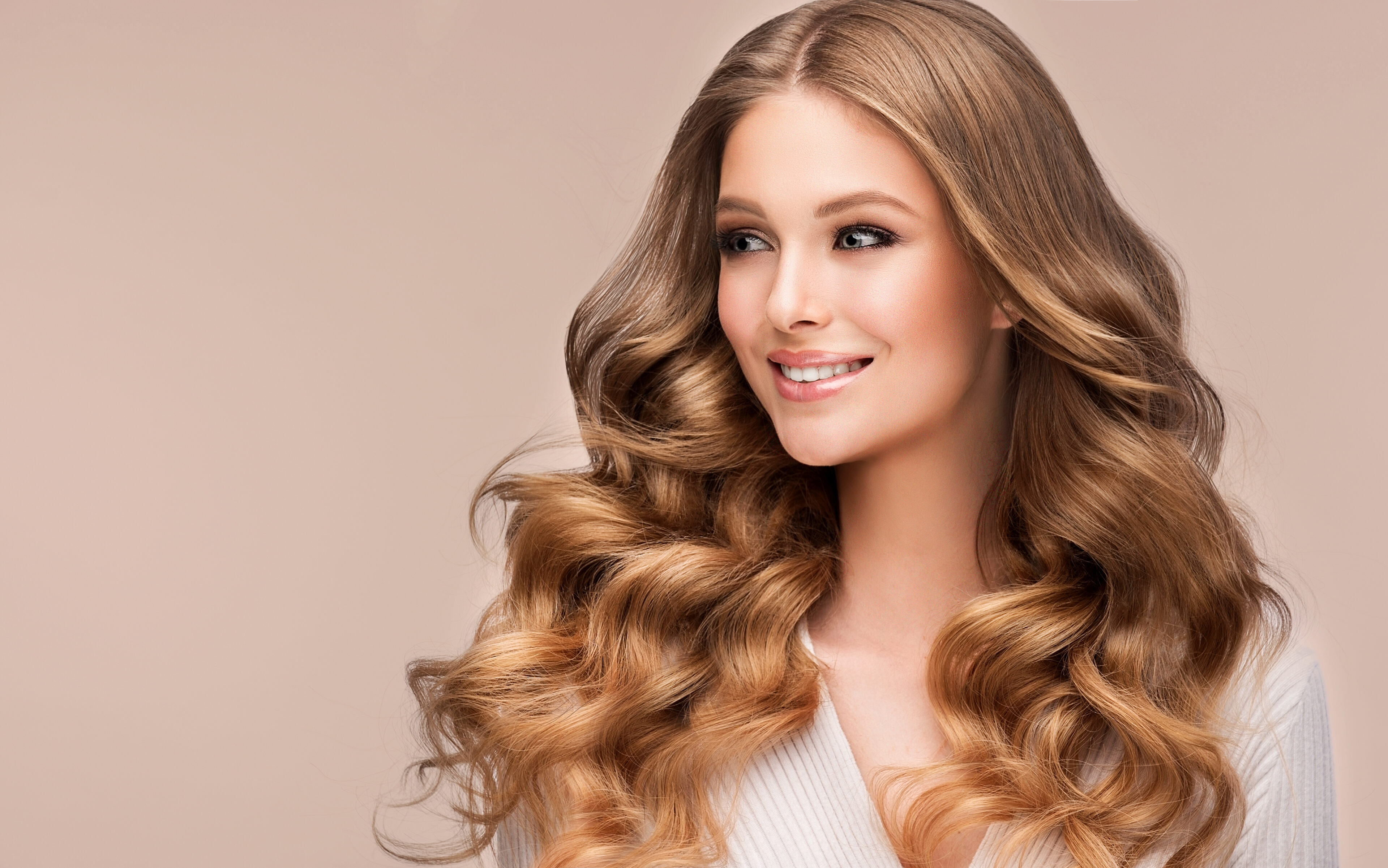 Beauty blonde girl with long and shiny wavy hair