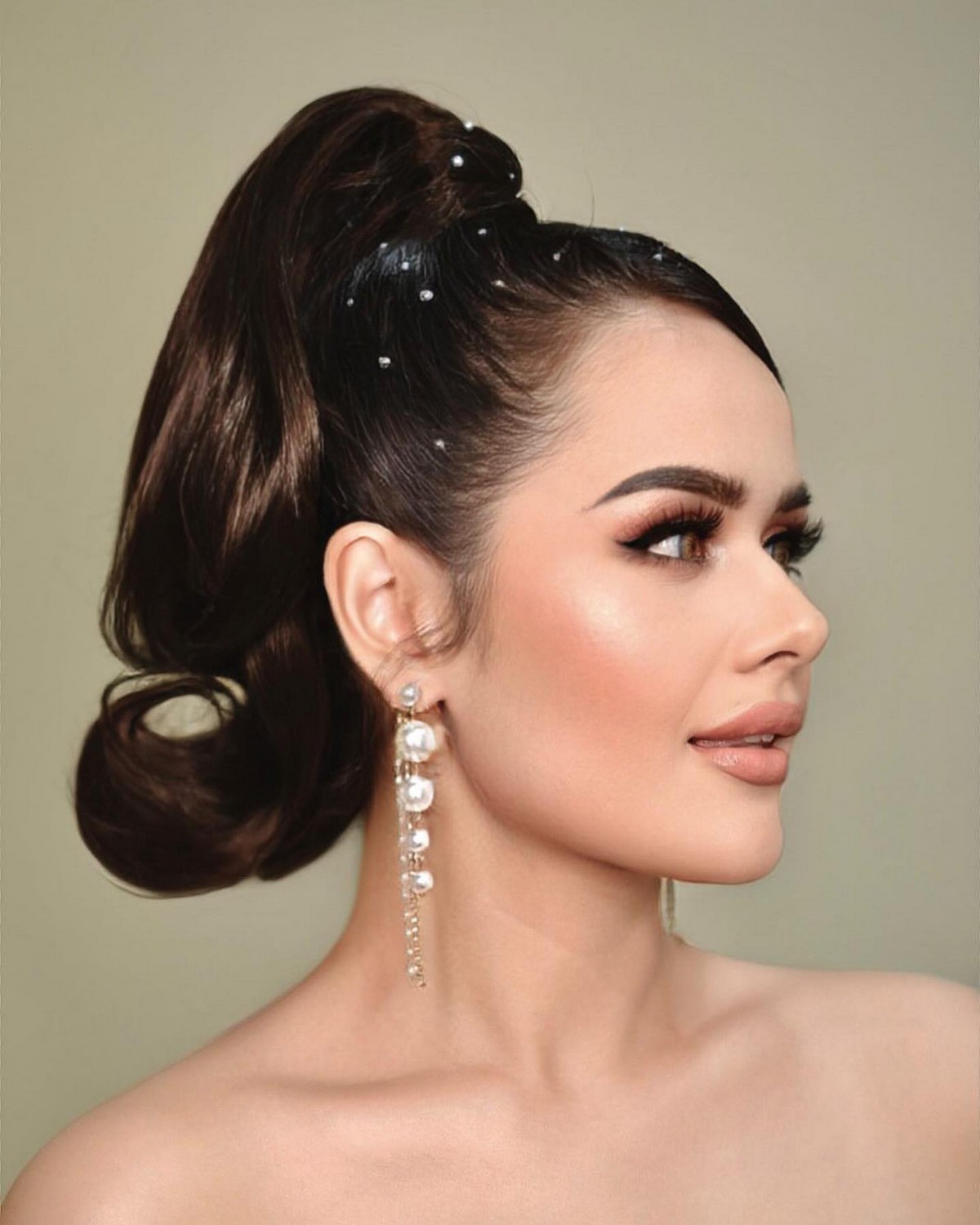 Slicked-back edges on the wavy ponytail